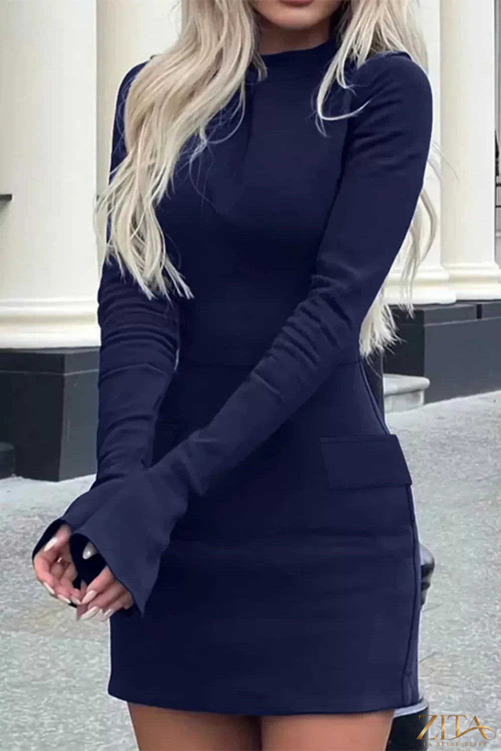 Long-sleeve mini dress with flap pockets by Trendsi, featuring a fitted silhouette and stylish design in a versatile fabric.