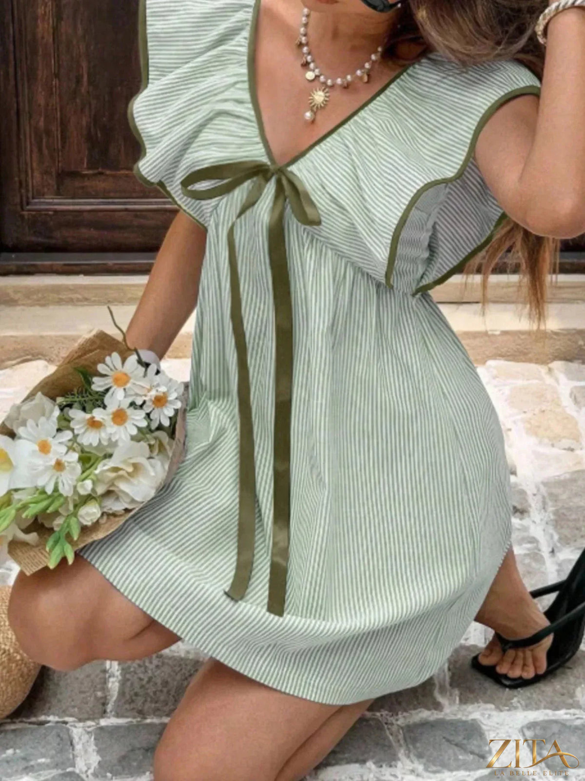 Striped ruffle sleeve mini dress by Trendsi featuring a fitted silhouette and playful ruffle details on the sleeves.