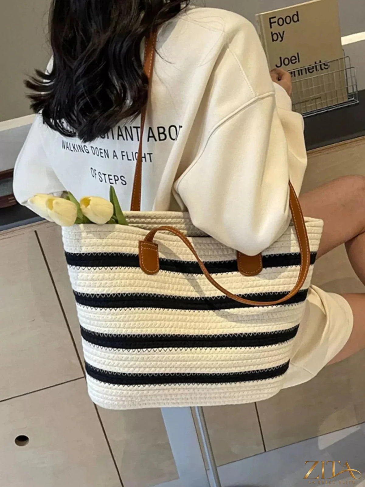 Striped straw tote bag by Zita La Belle Elite with woven handles and spacious interior, perfect for beach or casual outings.