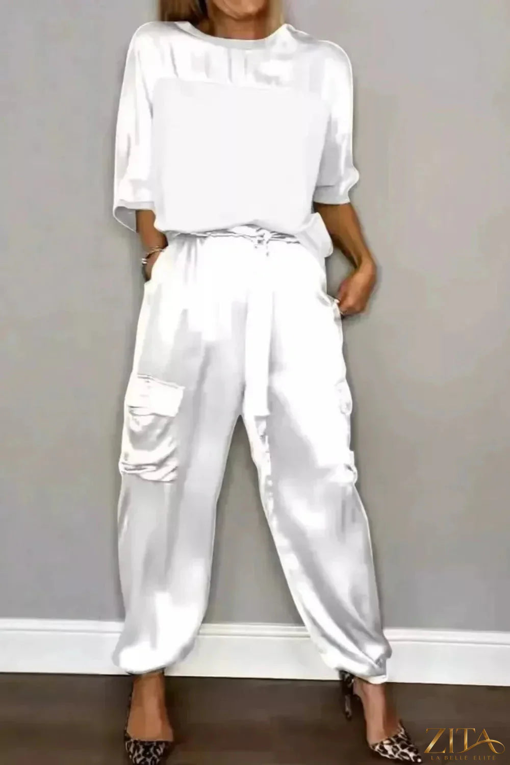 Satin round neck top and matching pants set by Trendsi, featuring a smooth, shiny fabric and comfortable fit for stylish wear.