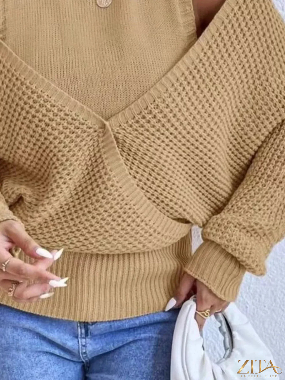 Waffle knit cold shoulder turtleneck sweater by Trendsi, featuring a cozy design with cut-out shoulders and a fitted turtleneck.