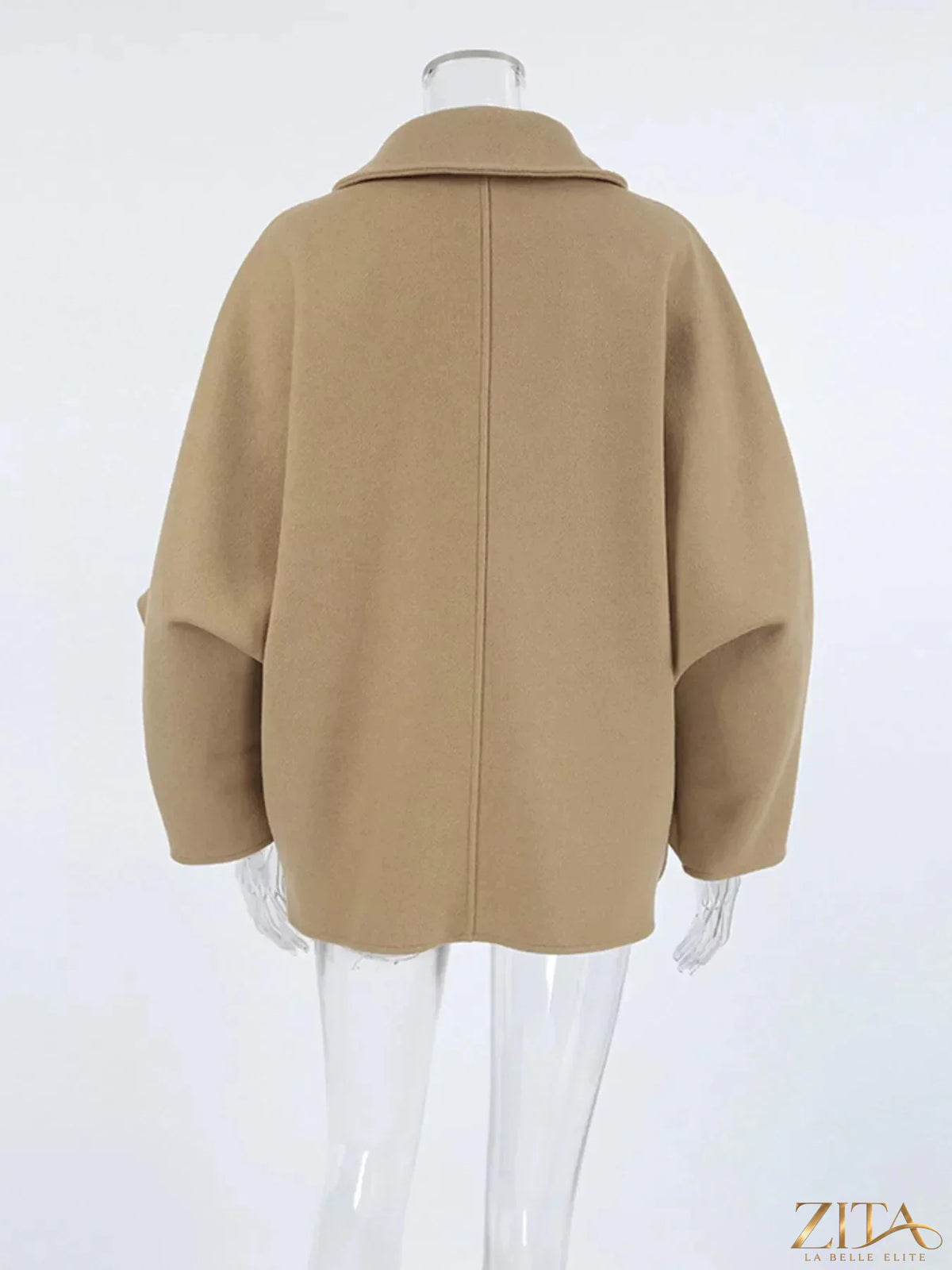 Zita La Belle Elite oversized lapel collar button-down coat hanging on a wooden rack, showcasing its stylish design and neutral color.