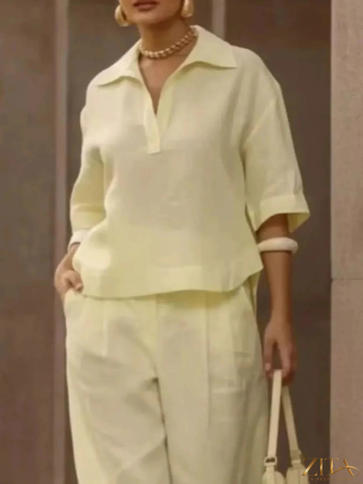 Plus size Zita La Belle Elite two-piece set with 3/4 sleeve top and wide-leg pants, showcased on a model.