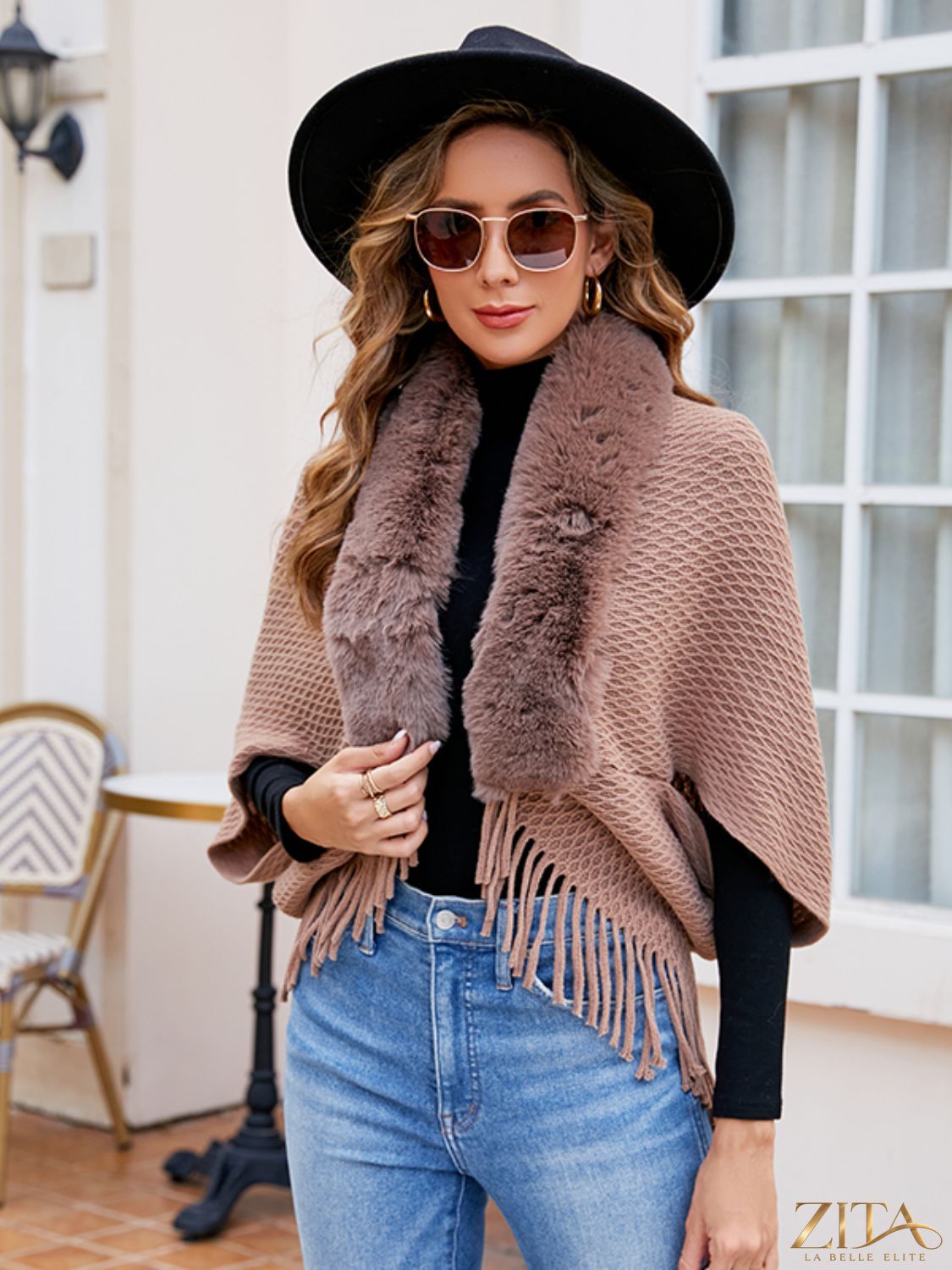 Open front fringe hem poncho by Trendsi, featuring a flowy design with fringe detailing at the hem and an open front style.