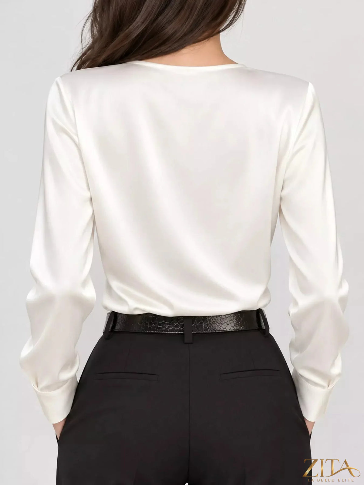 Zita La Belle Elite satin surplice long sleeve blouse with V-neck and draped design, shown in a close-up image.