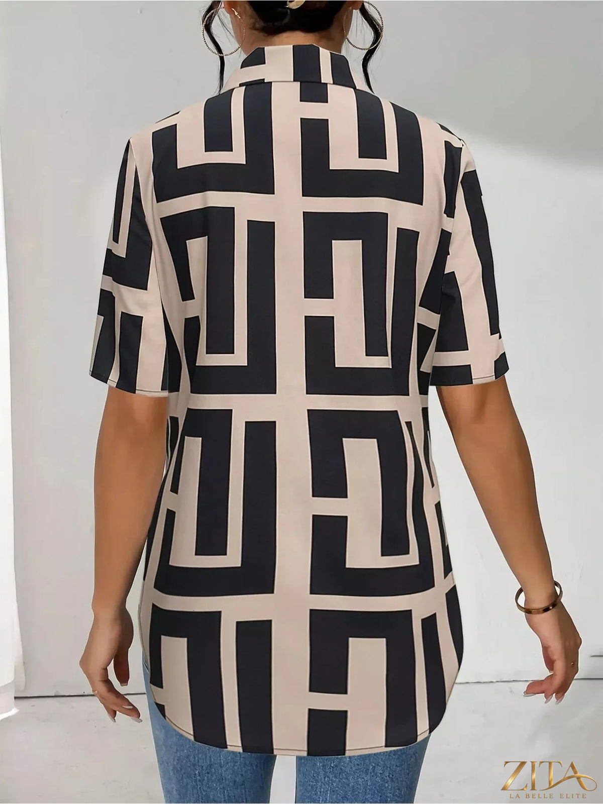 Zita La Belle Elite geometric print short sleeve button-down shirt with bold pattern and classic collar, displayed on a hanger.
