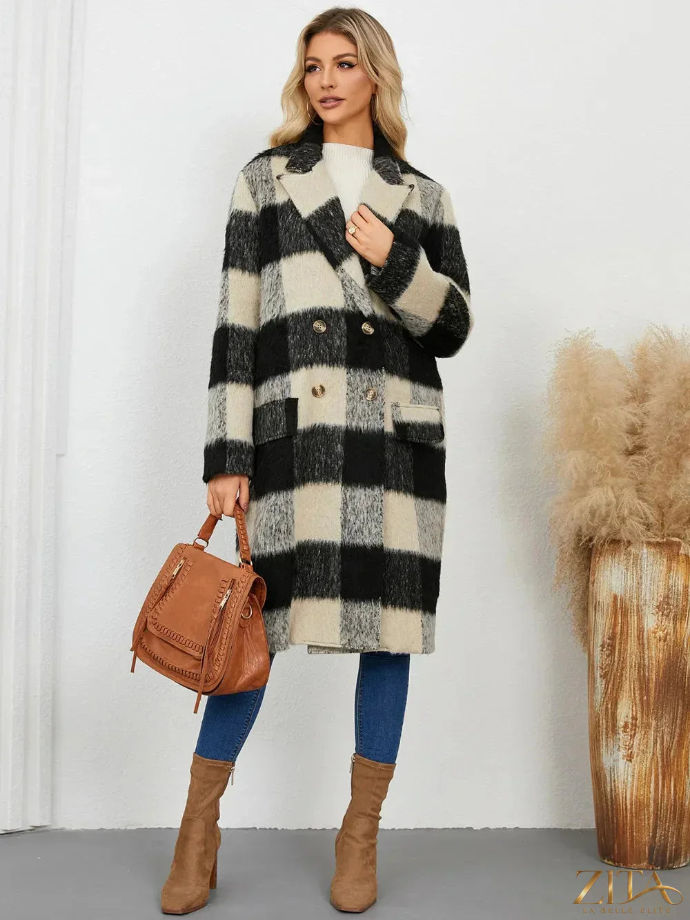 Zita La Belle Elite plaid double-breasted long sleeve coat hanging on a rack, featuring a classic check pattern and tailored fit.