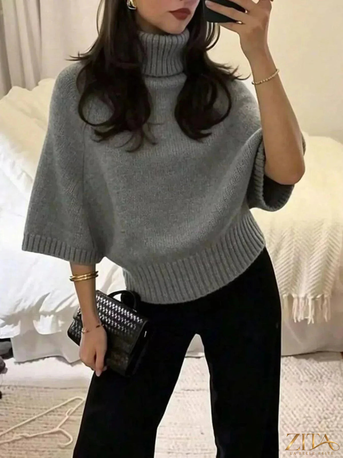 Black turtleneck batwing sleeve sweater by Trendsi, featuring a cozy fit and stylish design perfect for casual wear.