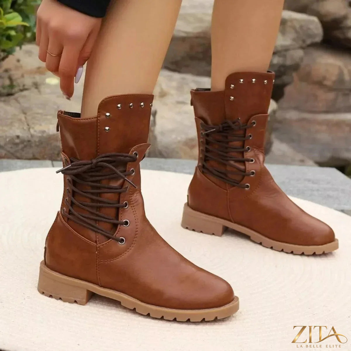 Trendsi studded lace-up boots with chunky heel and metallic accents, featuring black leather material and decorative studs.