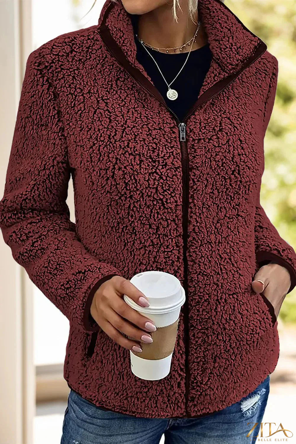 Trendsi pocketed zip-up turtleneck jacket shown in black, featuring a high neckline, front pockets, and a fitted style.