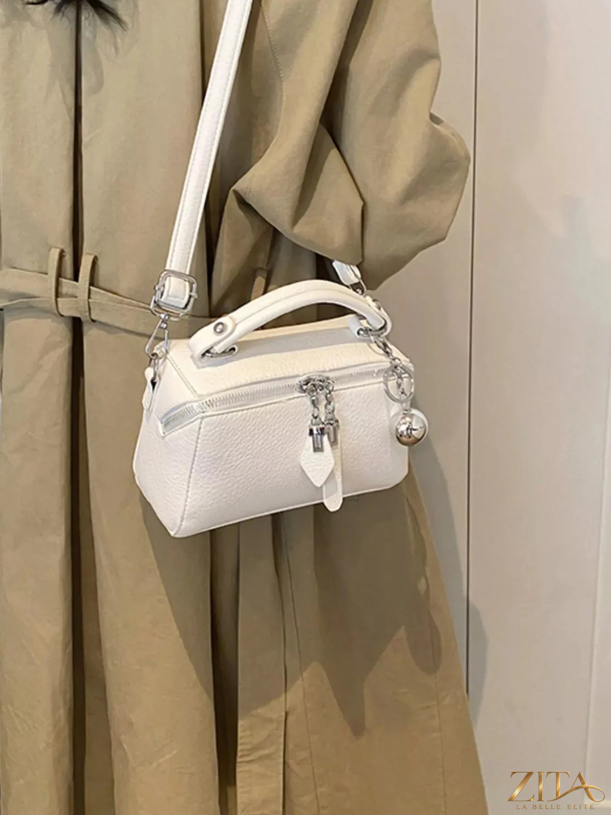 Textured leather handbag by Trendsi featuring a sleek design with sturdy handles and a spacious interior.