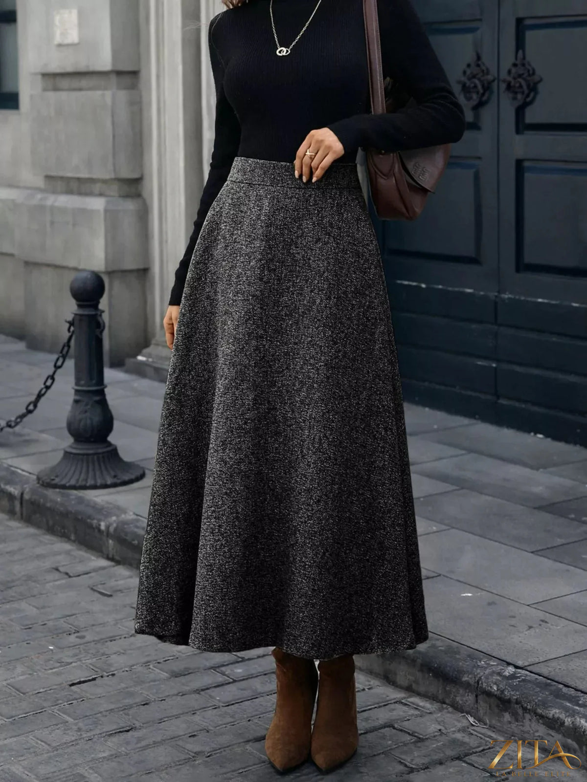 A-line midi skirt from Trendsi featuring a flowy design, high waist, and knee-length cut in a versatile fabric.