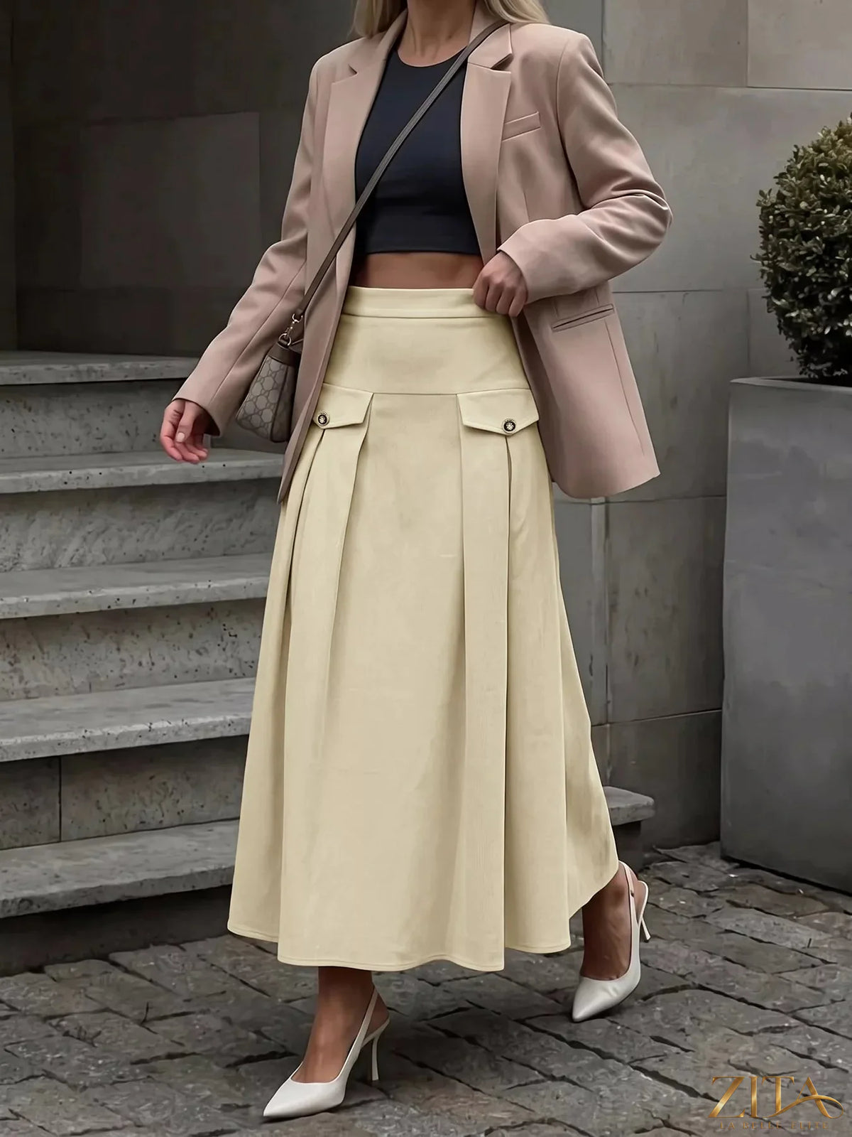 Zita La Belle Elite high waist pleated midi skirt in flowing fabric, showcasing its elegant design and pleated details.