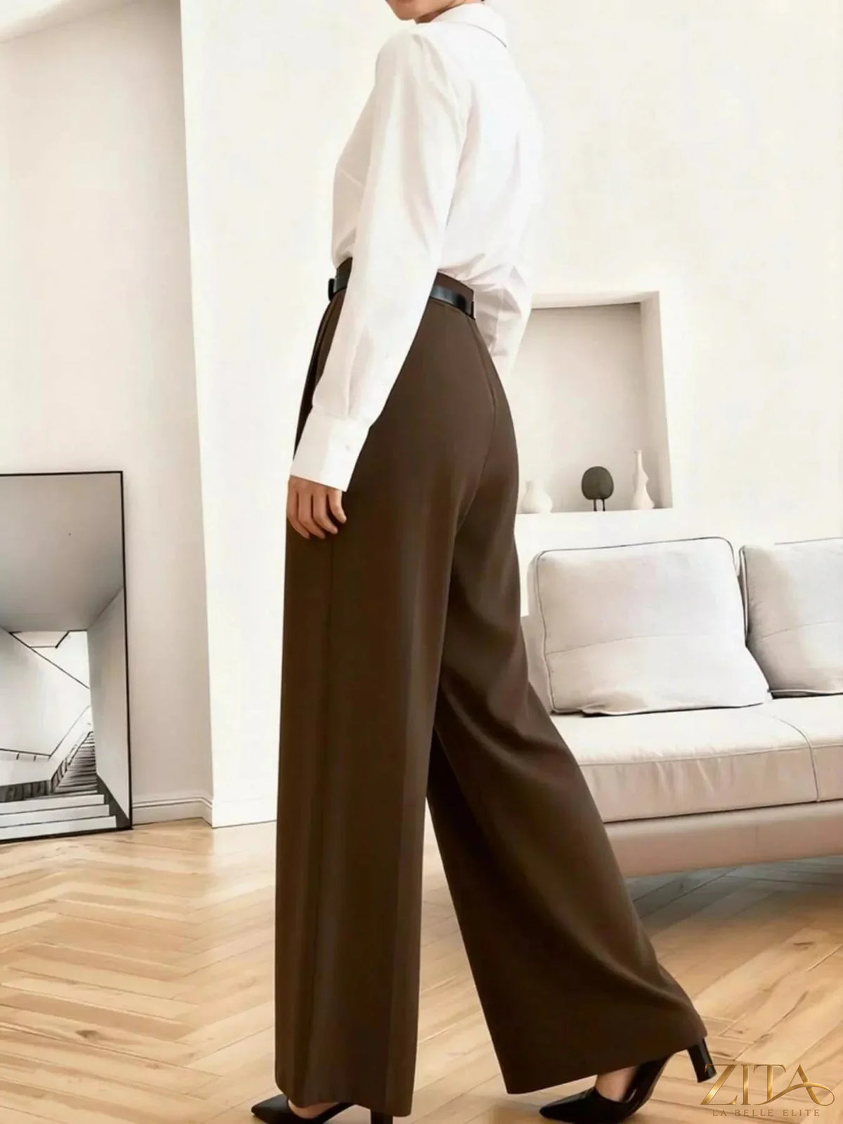 Zita La Belle Elite wide leg pleated pants in black, featuring high waist and flowing fabric, displayed on a model.