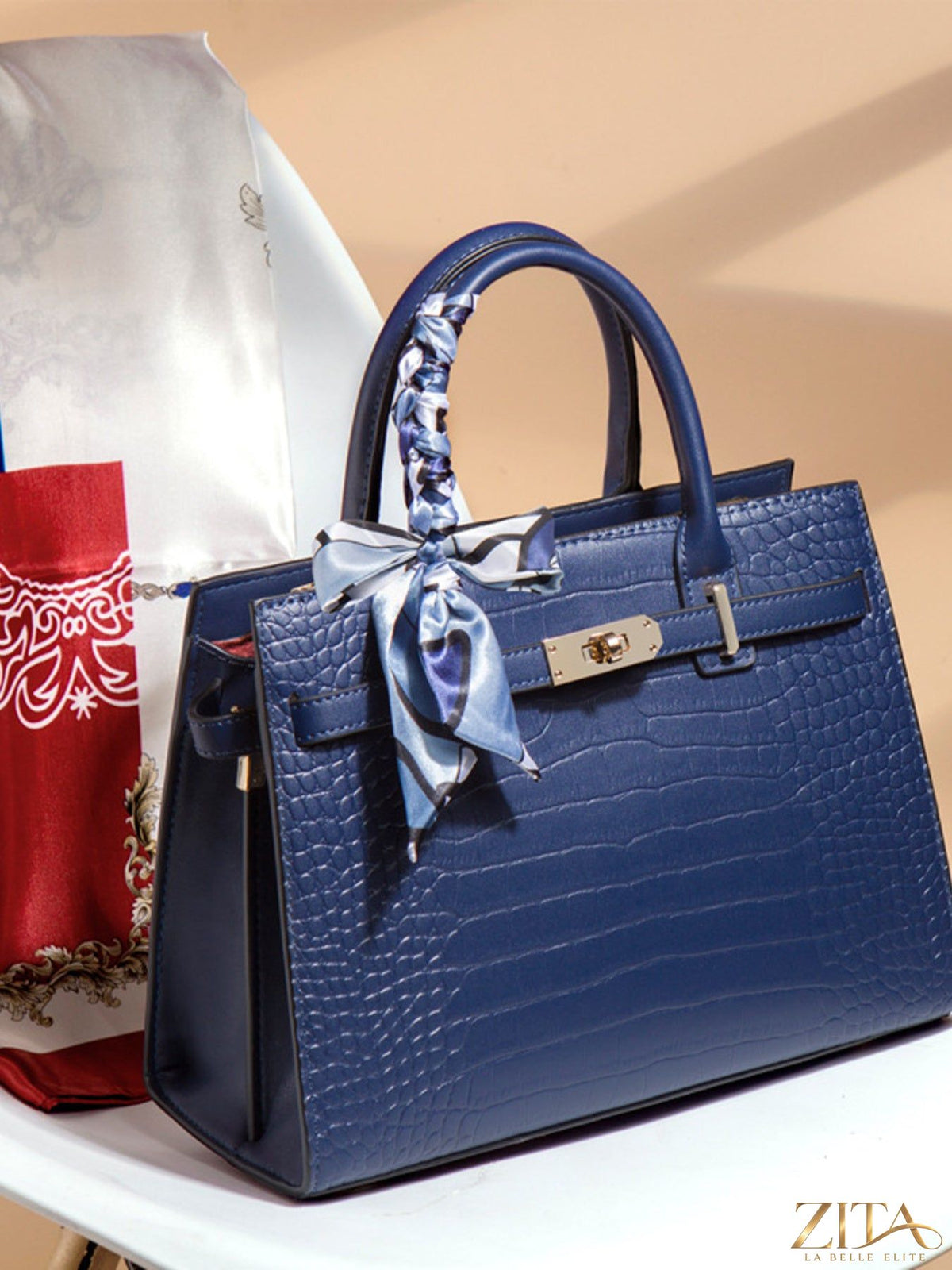 Crocodile embossed leather top handle handbag by Zita La Belle Elite, showcasing textured surface and elegant design.
