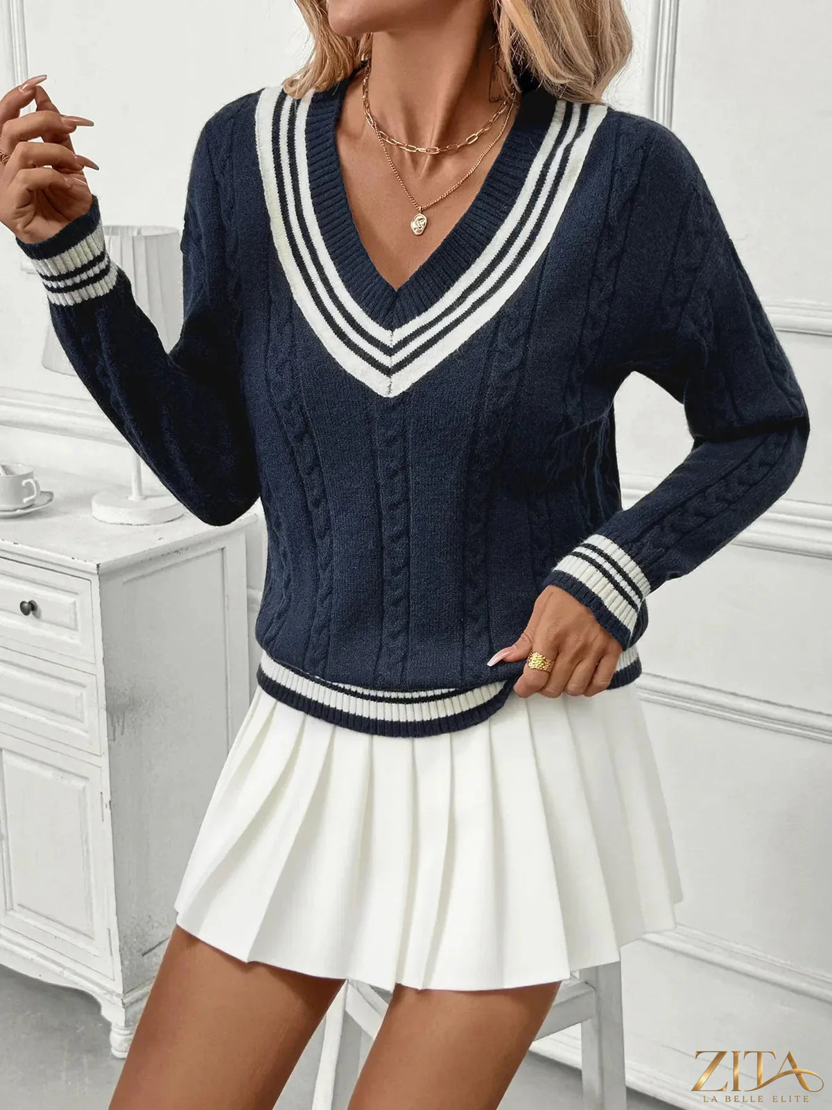 Zita La Belle Elite contrast striped V-neck sweater with ribbed cuffs and hem, featuring bold black and white horizontal stripes.