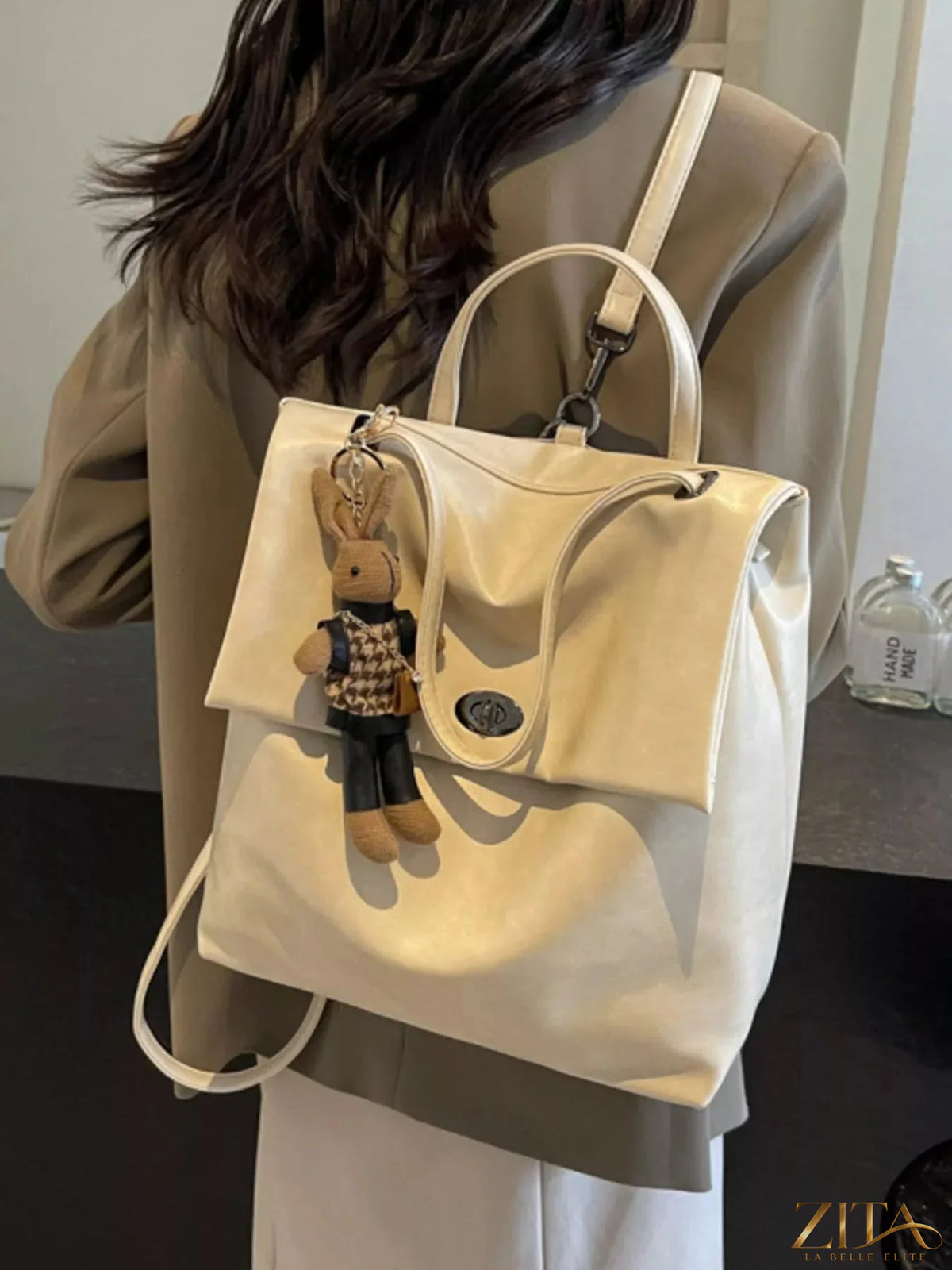 Leather flap backpack bag by Trendsi featuring a sleek design with adjustable straps and a spacious main compartment.