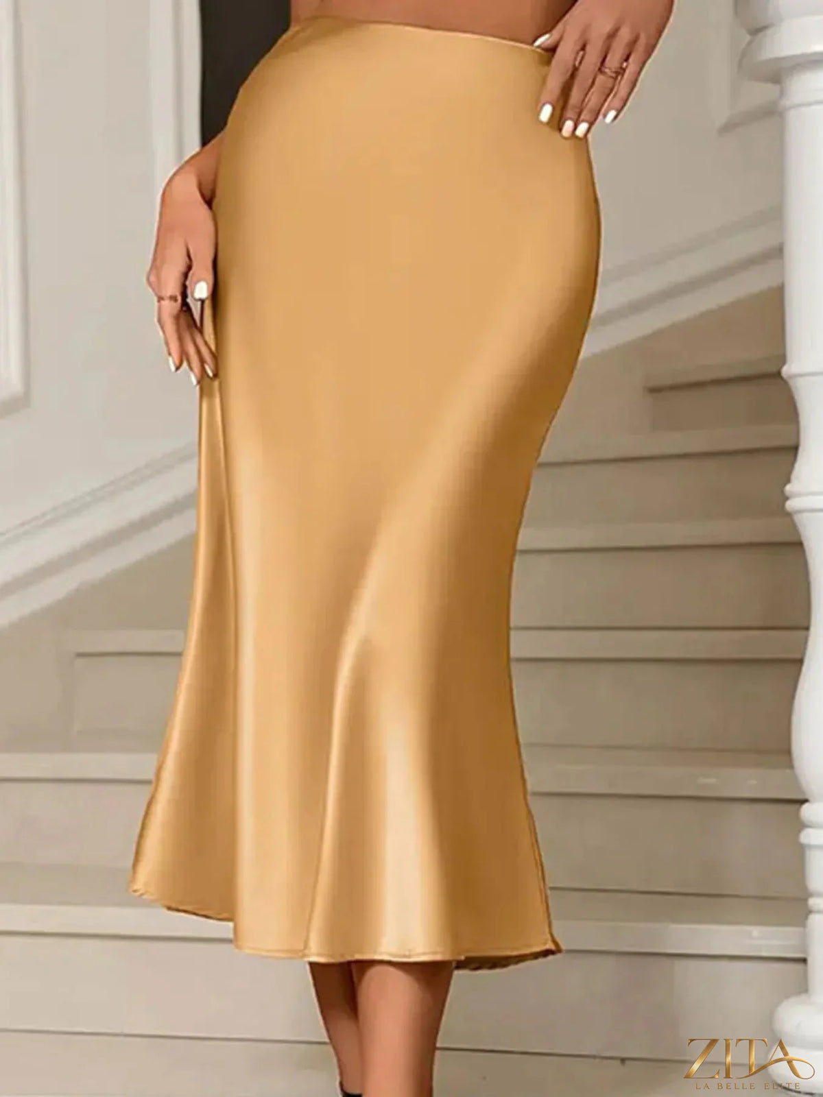 Satin midi mermaid skirt in a smooth, shiny fabric with a fitted silhouette and flared hem, styled for elegant occasions.