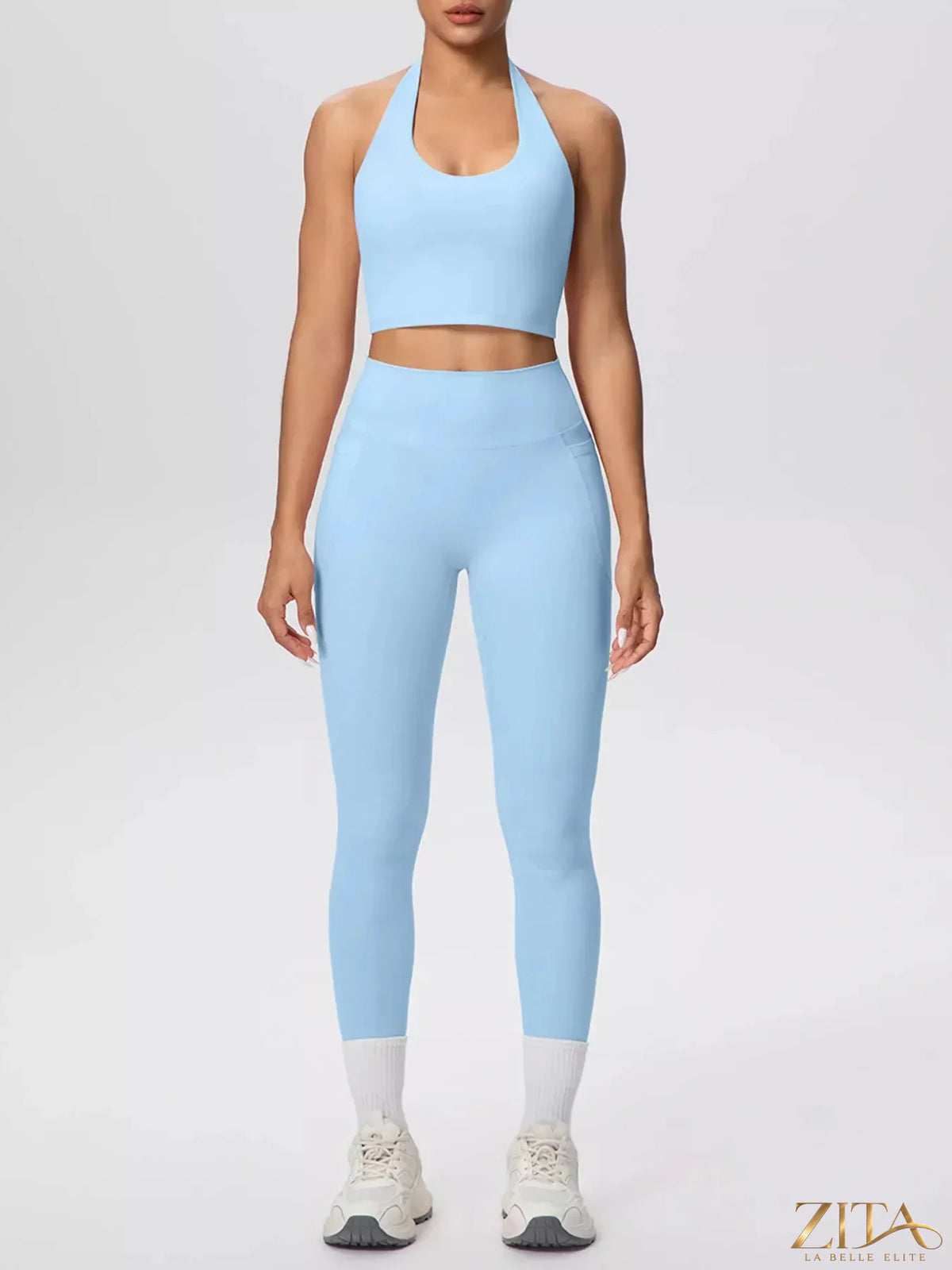 Zita La Belle Elite halter neck crop top and high-waisted leggings active set, shown on a woman, in a sleek, stylish sportswear design.