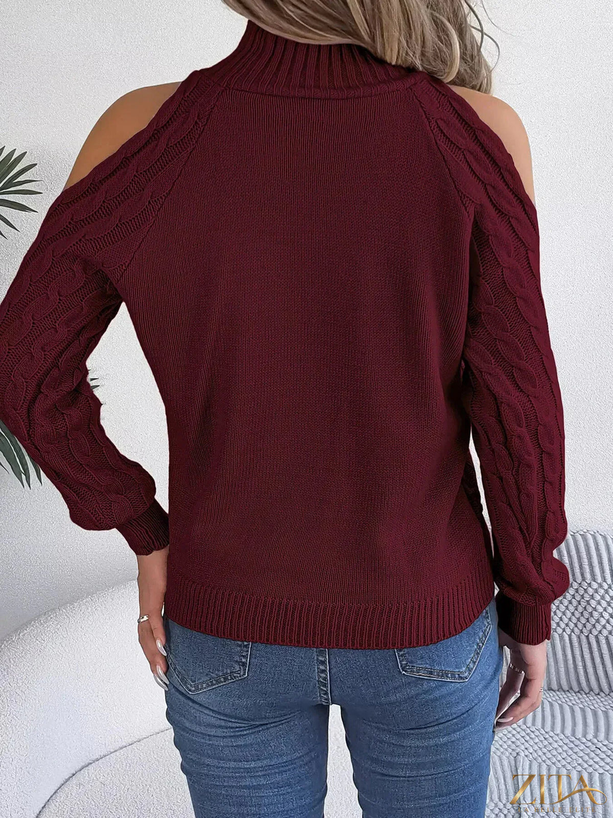 Zita La Belle Elite cold-shoulder cable knit sweater in soft fabric, featuring open shoulder design and cozy textured knitting.