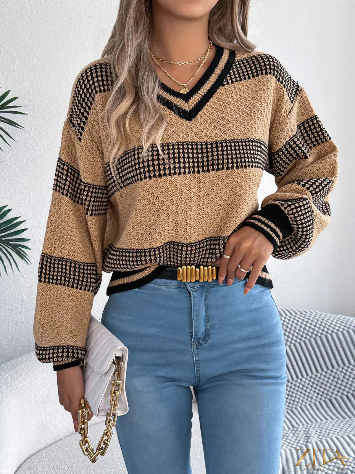 Contrast striped V-neck sweater by Trendsi, featuring a stylish V-neck design and bold stripe pattern, shown in the image.
