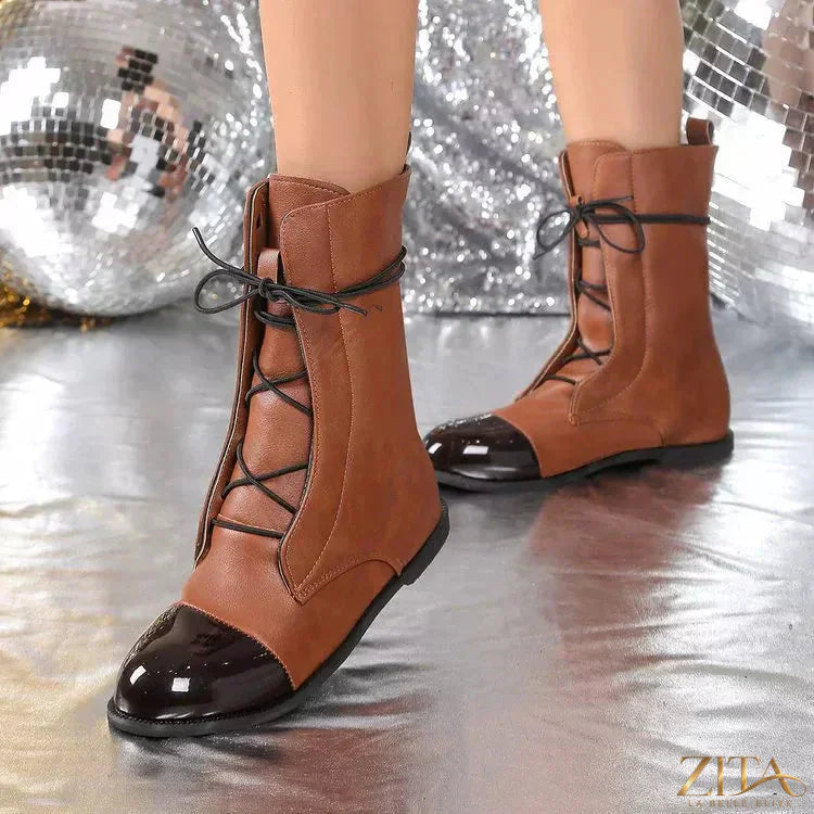 Trendsi lace-up leather boots with sturdy soles, stylish design, and ankle-high cut, perfect for casual or edgy outfits.