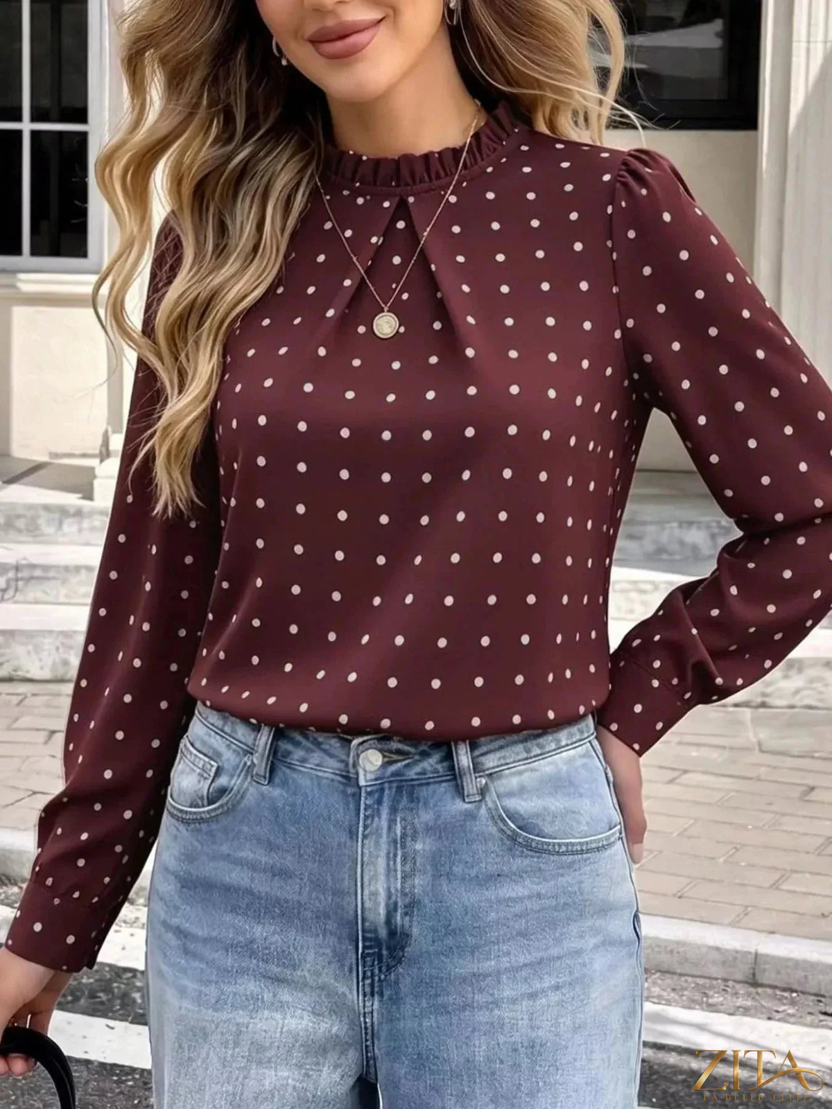 Zita La Belle Elite polka dot print mock neck long sleeve blouse with elegant design and stylish fit on a model.