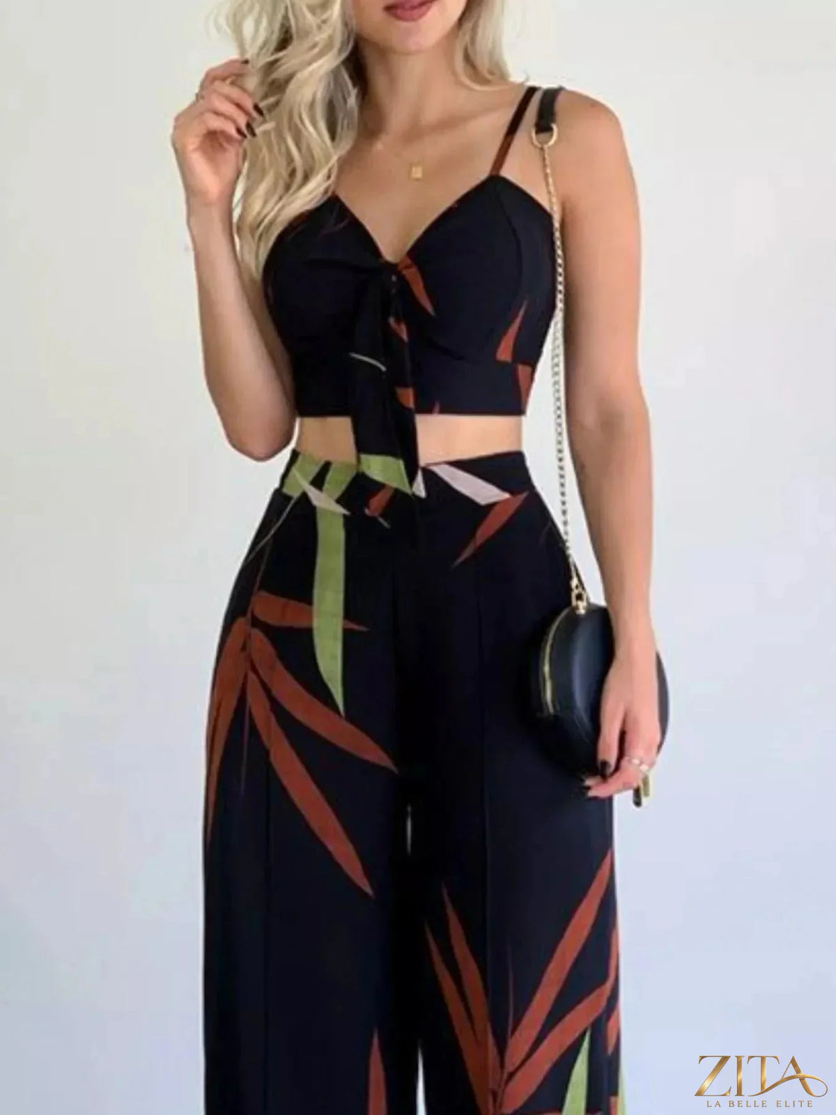 Tropical print spaghetti strap crop top and wide-leg pants set by Zita La Belle Elite, featuring vibrant floral design.