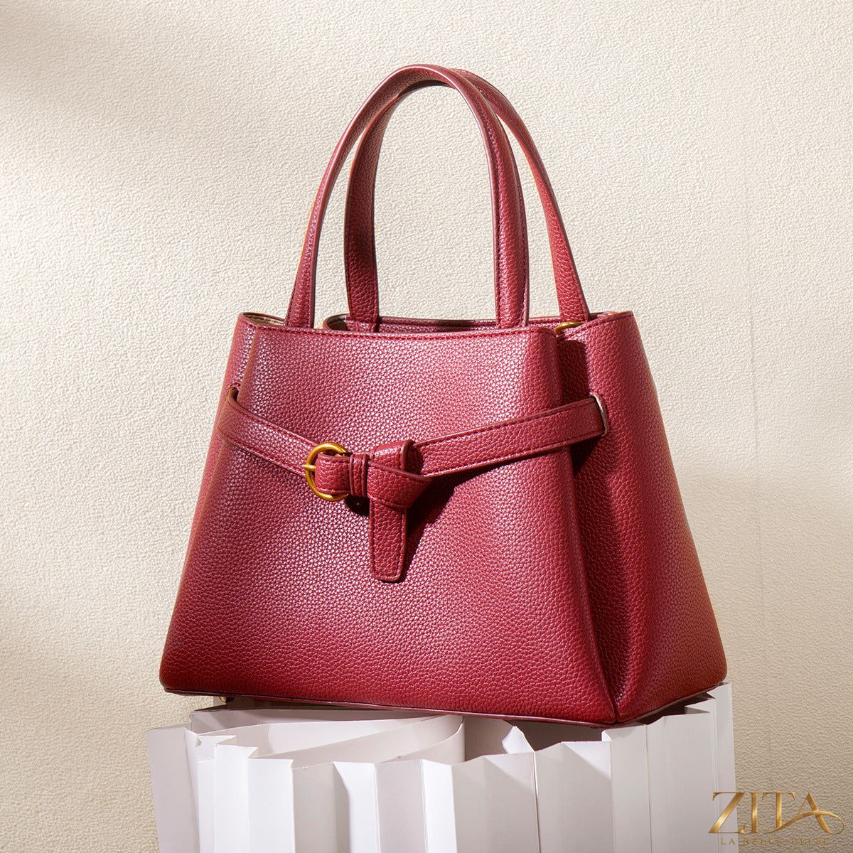 Zita La Belle Elite leather top handle handbag with gold hardware and structured design, showcasing its elegant craftsmanship.