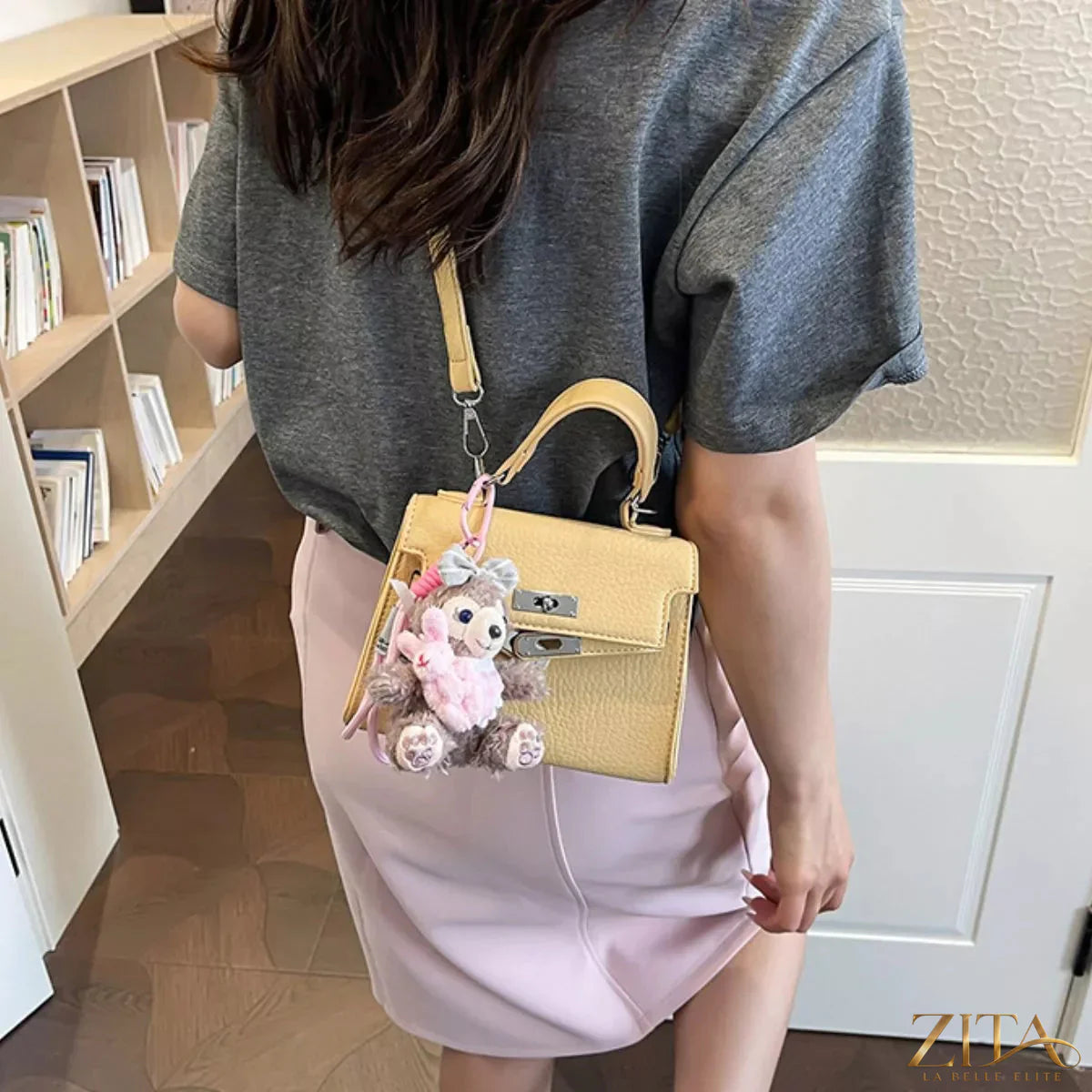 Trendsi PU leather handbag with sleek design, featuring a structured shape, top handles, and elegant stitching on smooth black leather.