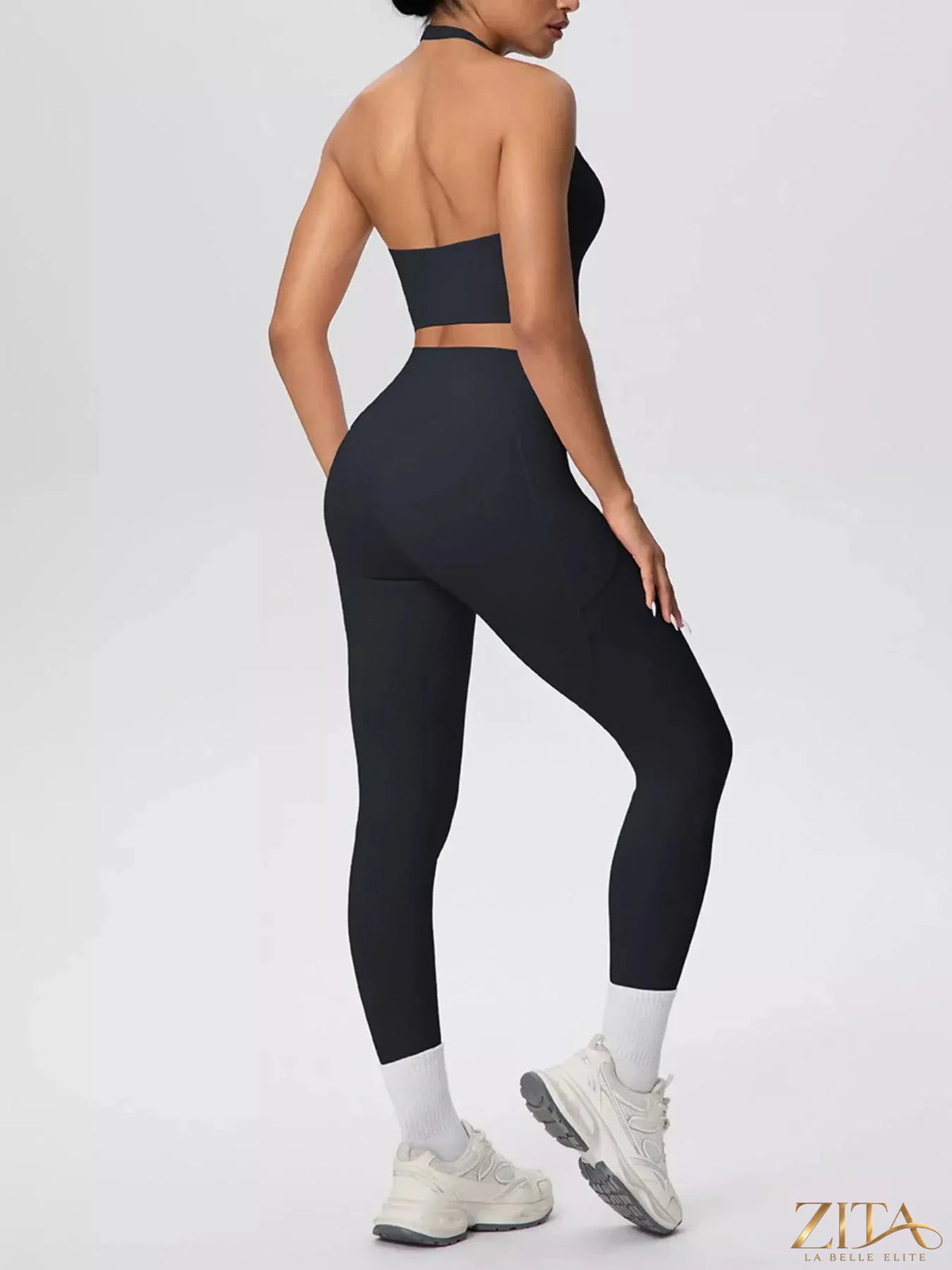 Zita La Belle Elite halter neck crop top and high-waisted leggings active set worn by a model in a gym setting