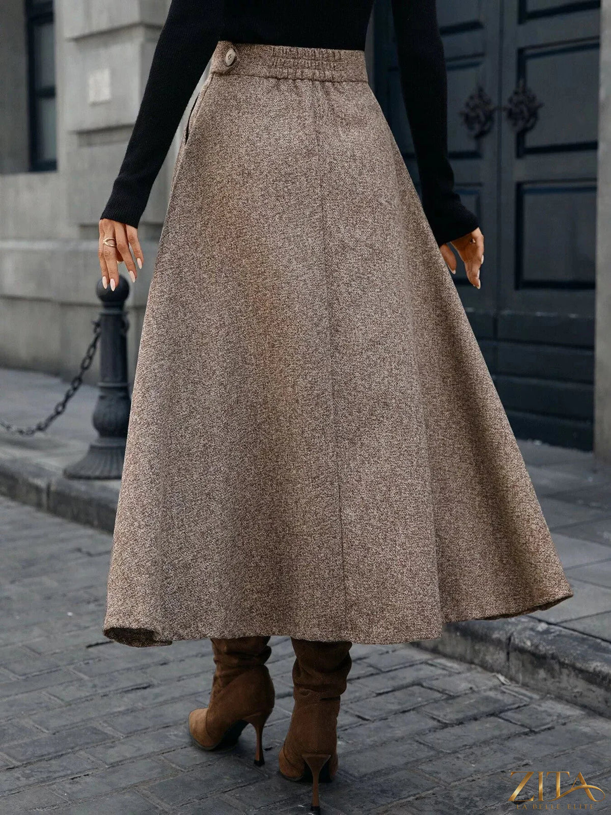 A-line midi skirt from Trendsi featuring a flowy silhouette and neutral color, shown on a model.