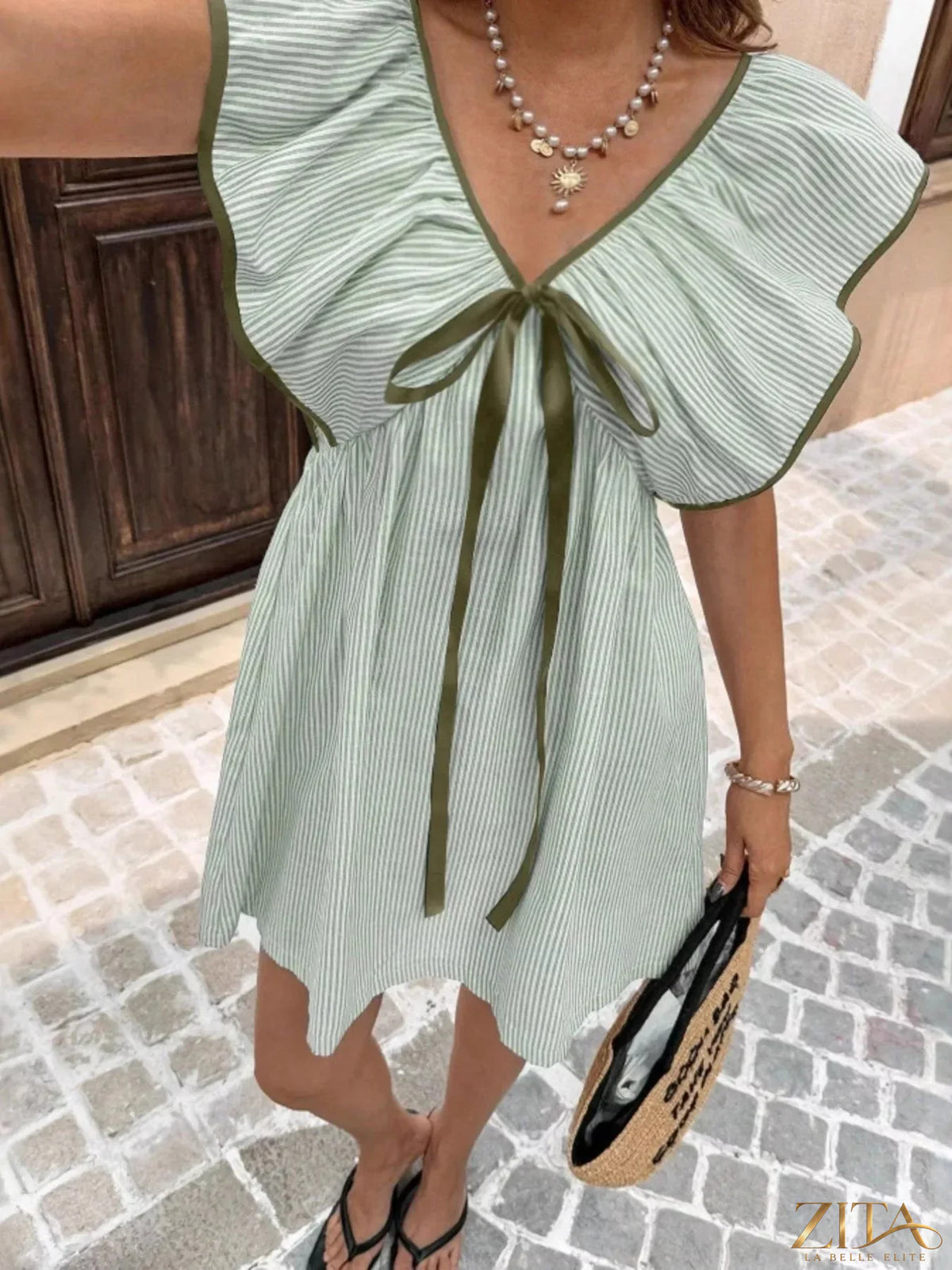 Striped ruffle sleeve mini dress by Trendsi featuring a fitted bodice, playful ruffle sleeves, and a stylish mini length.