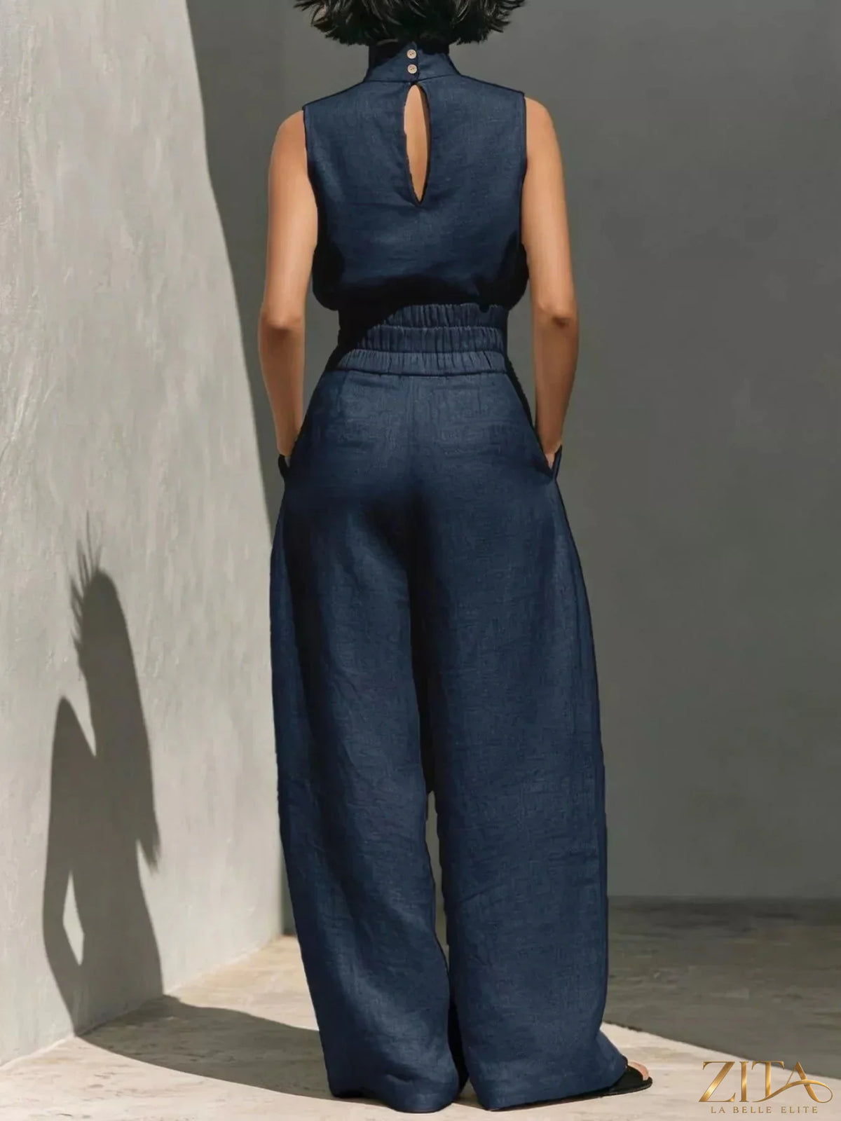 Sleeveless turtleneck top and wide-leg pants set by Trendsi, shown in a stylish, coordinated outfit on a model.