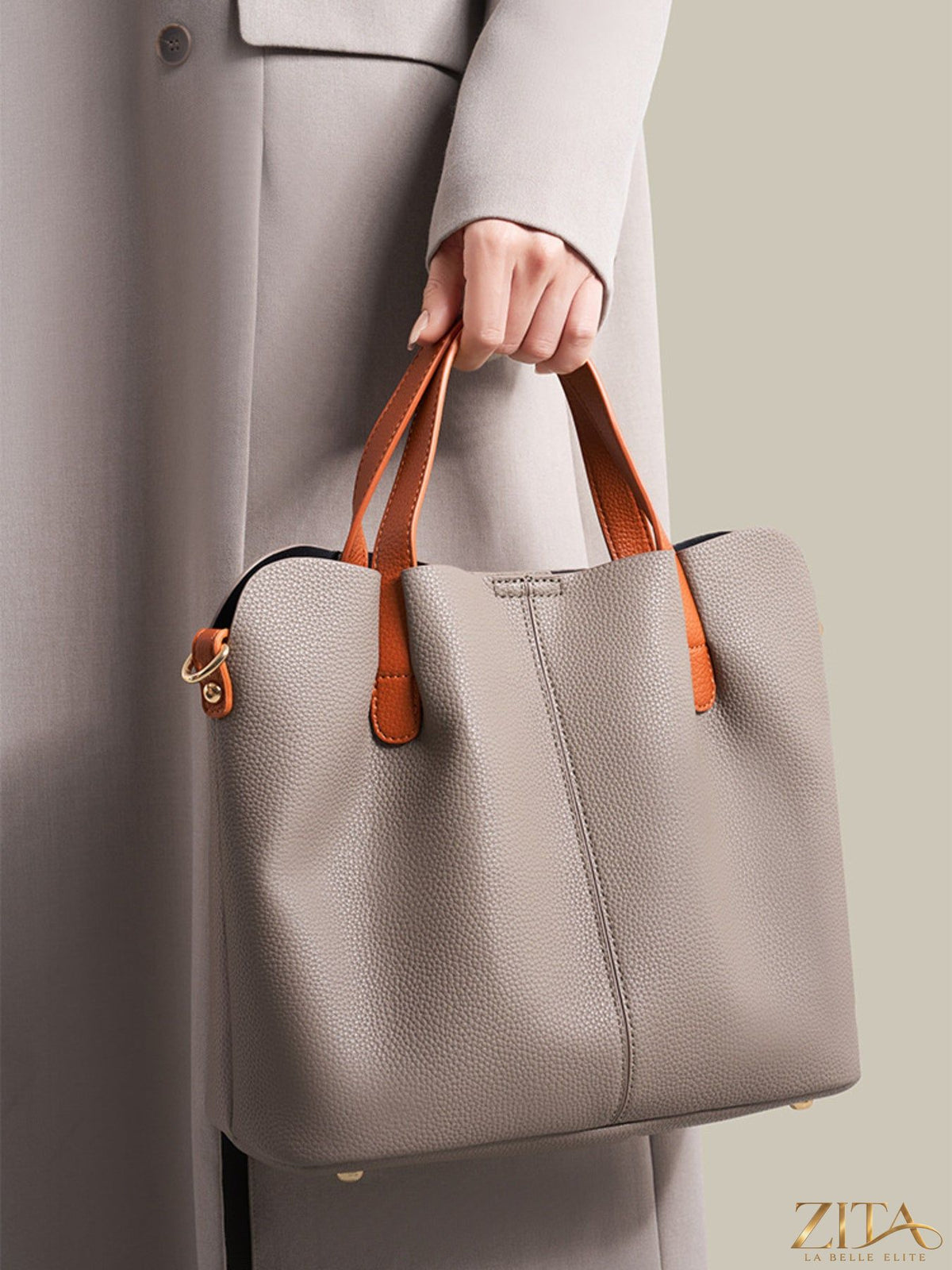 Leather contrast handle handbag by Trendsi with stylish black and brown leather accents, featuring a spacious interior and elegant design.