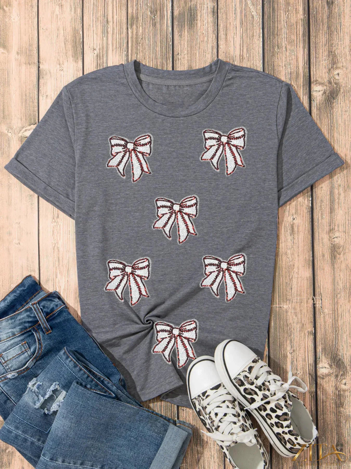Sequin bow short sleeve T-shirt from Trendsi featuring a sparkling sequin bow design on the front.