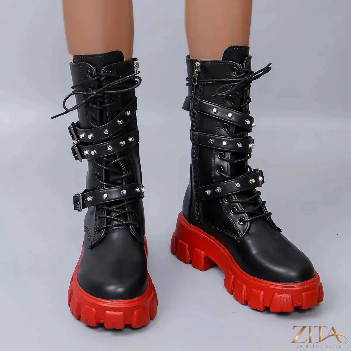 Black buckled lace-up combat boots from Trendsi with sturdy soles and metal eyelets, stylish and durable footwear for edgy fashion.