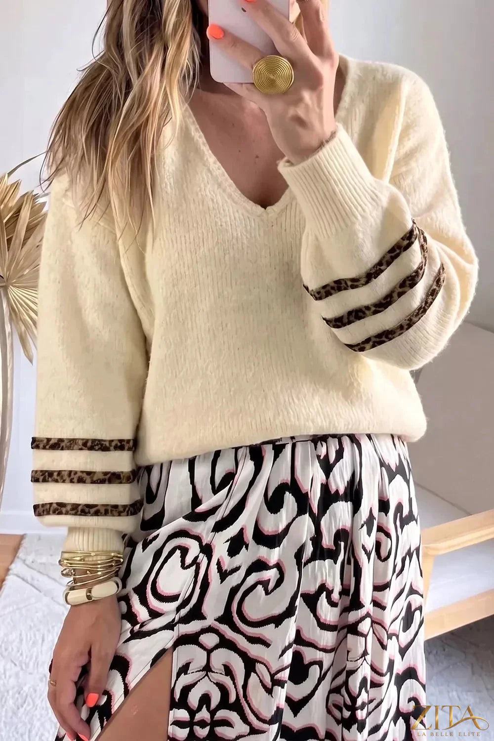 Leopard striped V-neck sweater by Zita La Belle Elite, featuring a cozy knit with bold animal print and a classic V-neck design.