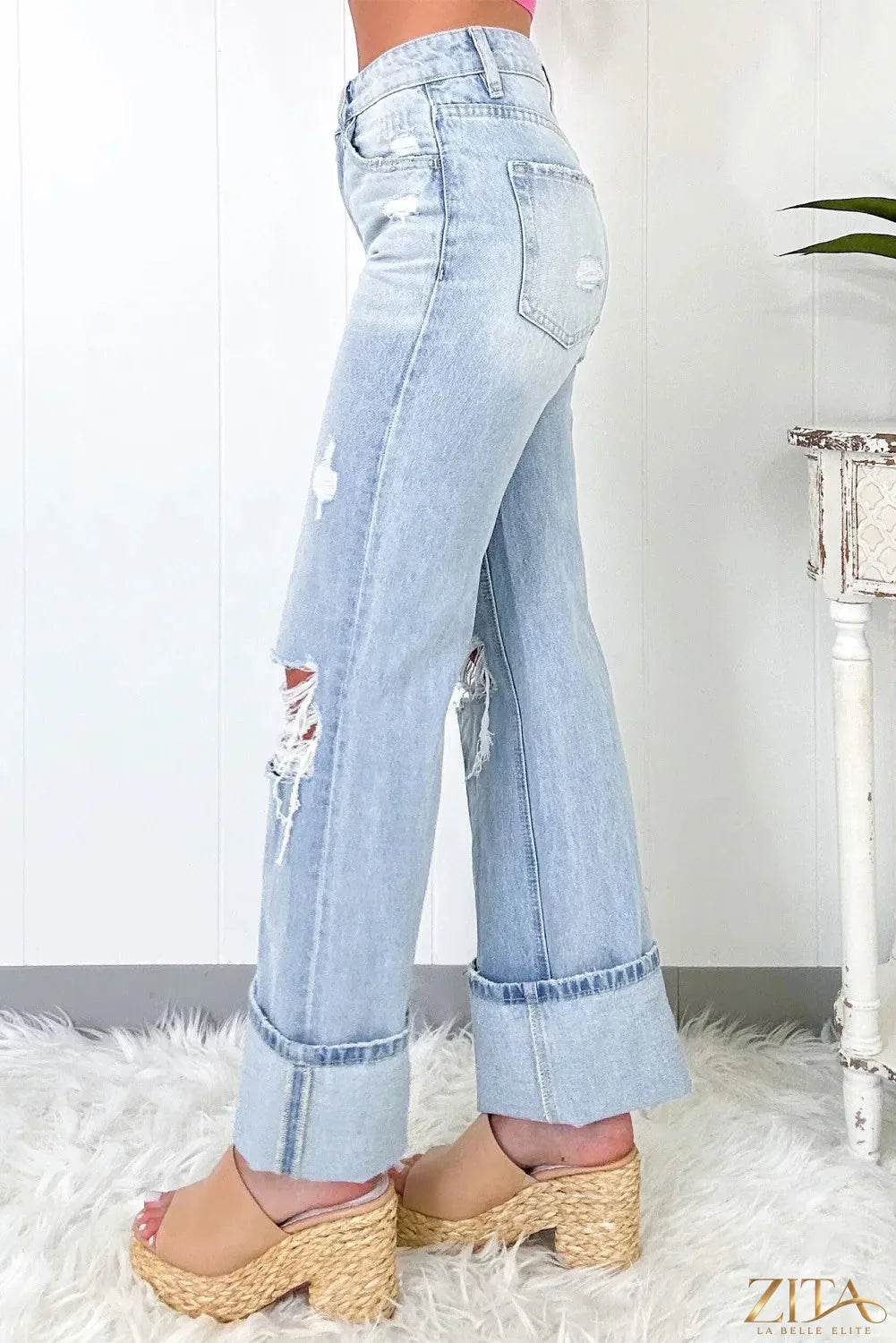 Distressed high waist jeans with pockets by Zita La Belle Elite, showcasing a trendy, ripped denim design and classic five-pocket style.