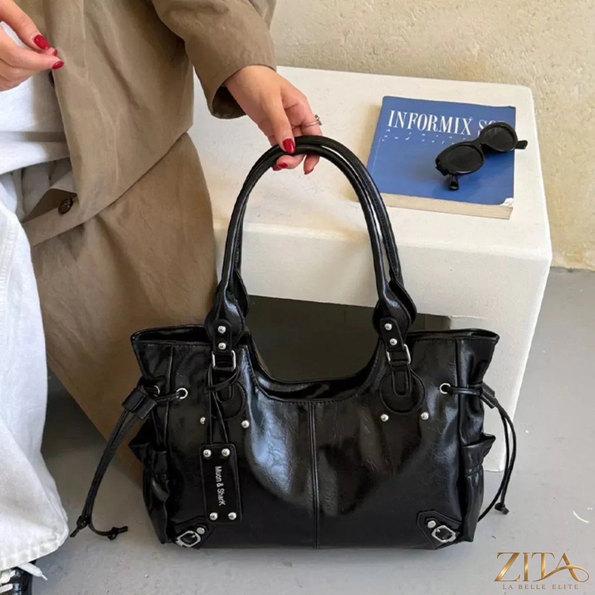 Drawstring leather handbag by Trendsi, featuring a stylish design with a sleek leather finish and adjustable drawstring closure.