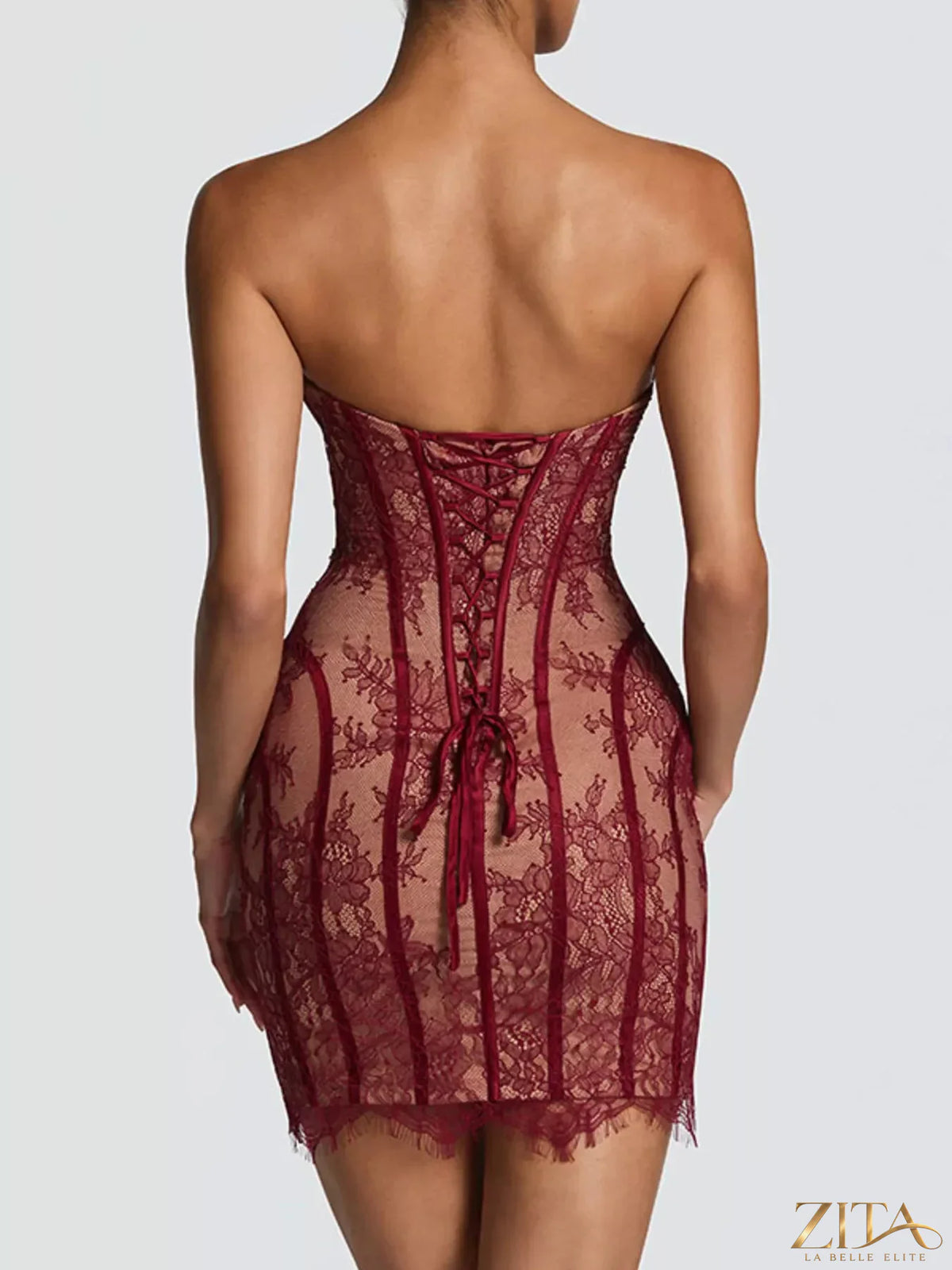 Lace detail tube mini dress by Trendsi, featuring a fitted silhouette with intricate lace accents and sleeveless design.