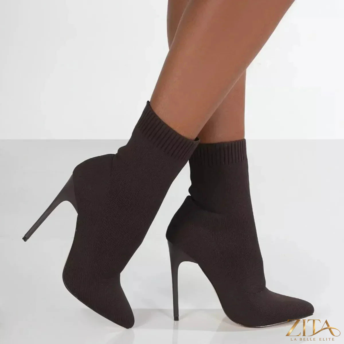 Point toe stiletto boots by Zita La Belle Elite featuring sleek black leather and high stiletto heel on a white background.