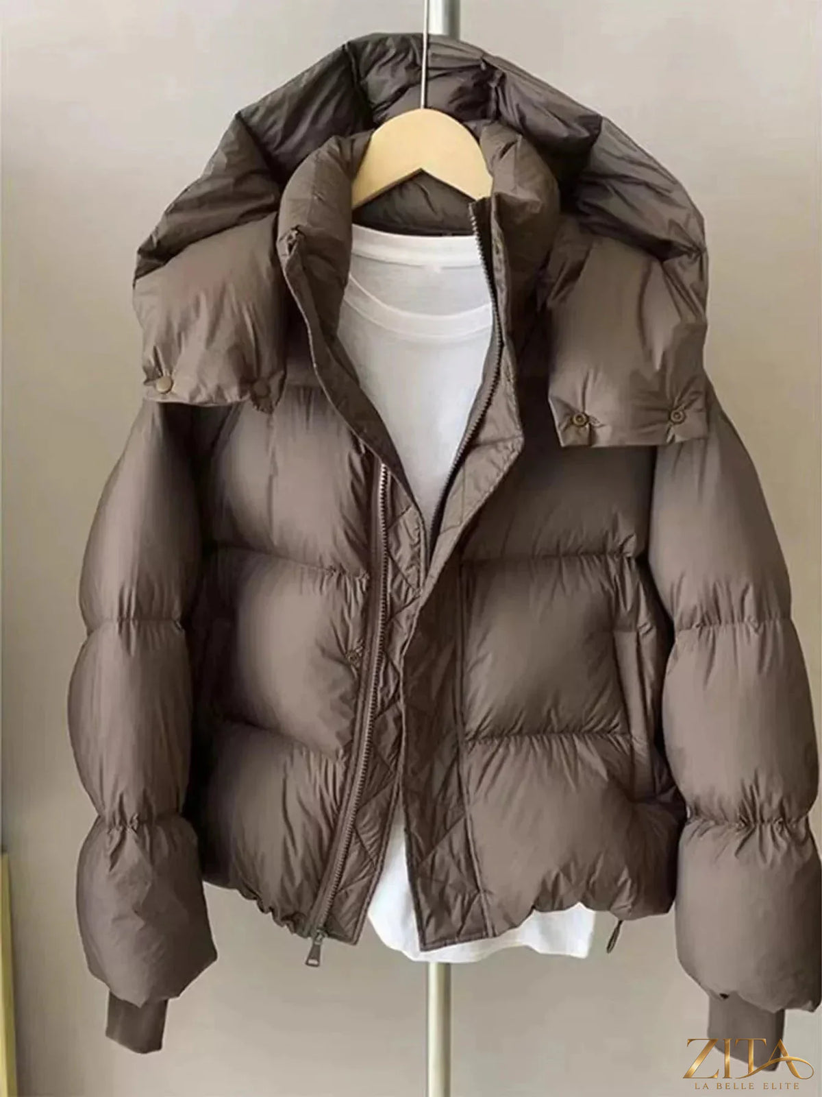 Zita La Belle Elite quilted hooded puffer jacket in black with a shiny quilted texture and adjustable drawstring hood.