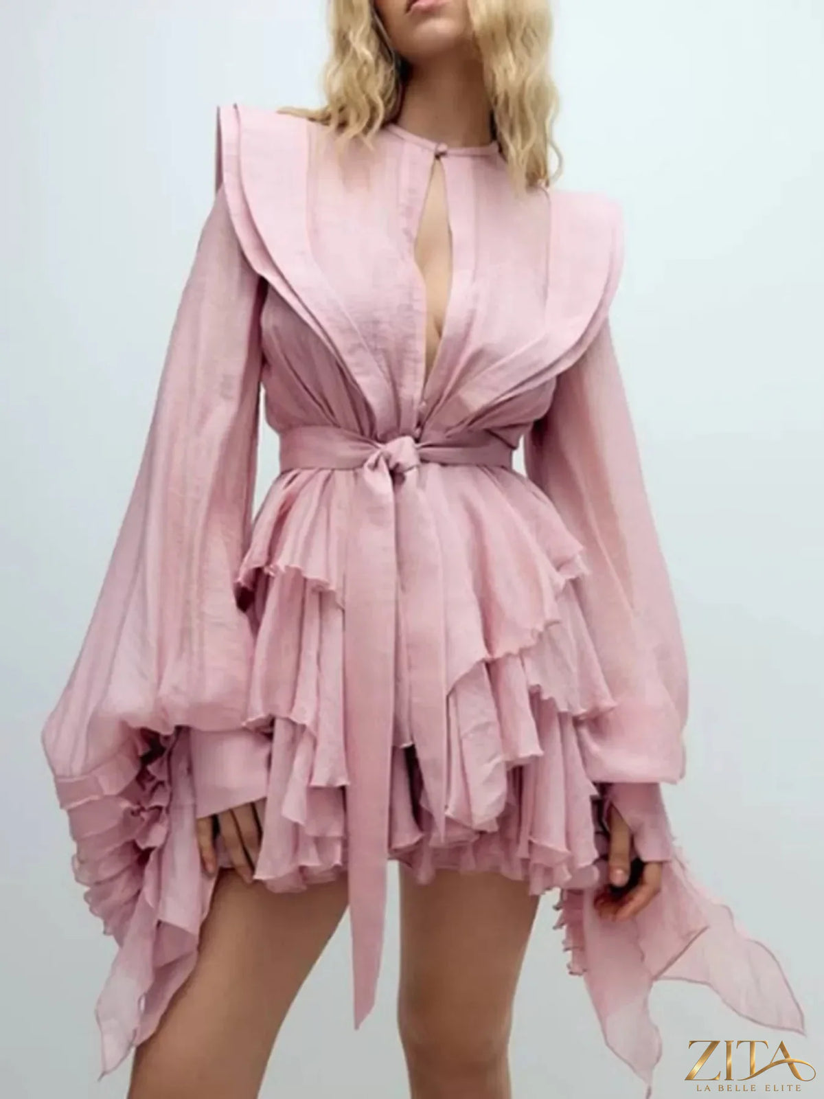 Ruffled long sleeve mini dress by Trendsi featuring a flowy silhouette and feminine ruffle details.