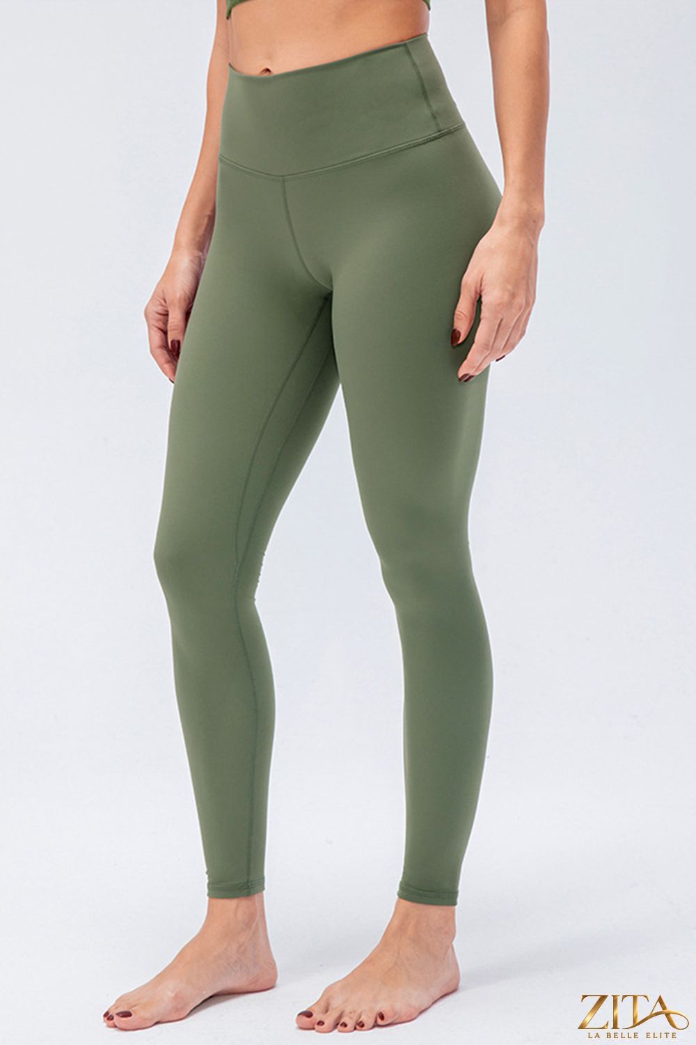 High-waisted slim fit active leggings with wide waistband from Trendsi, shown on a model, in a sleek black color.