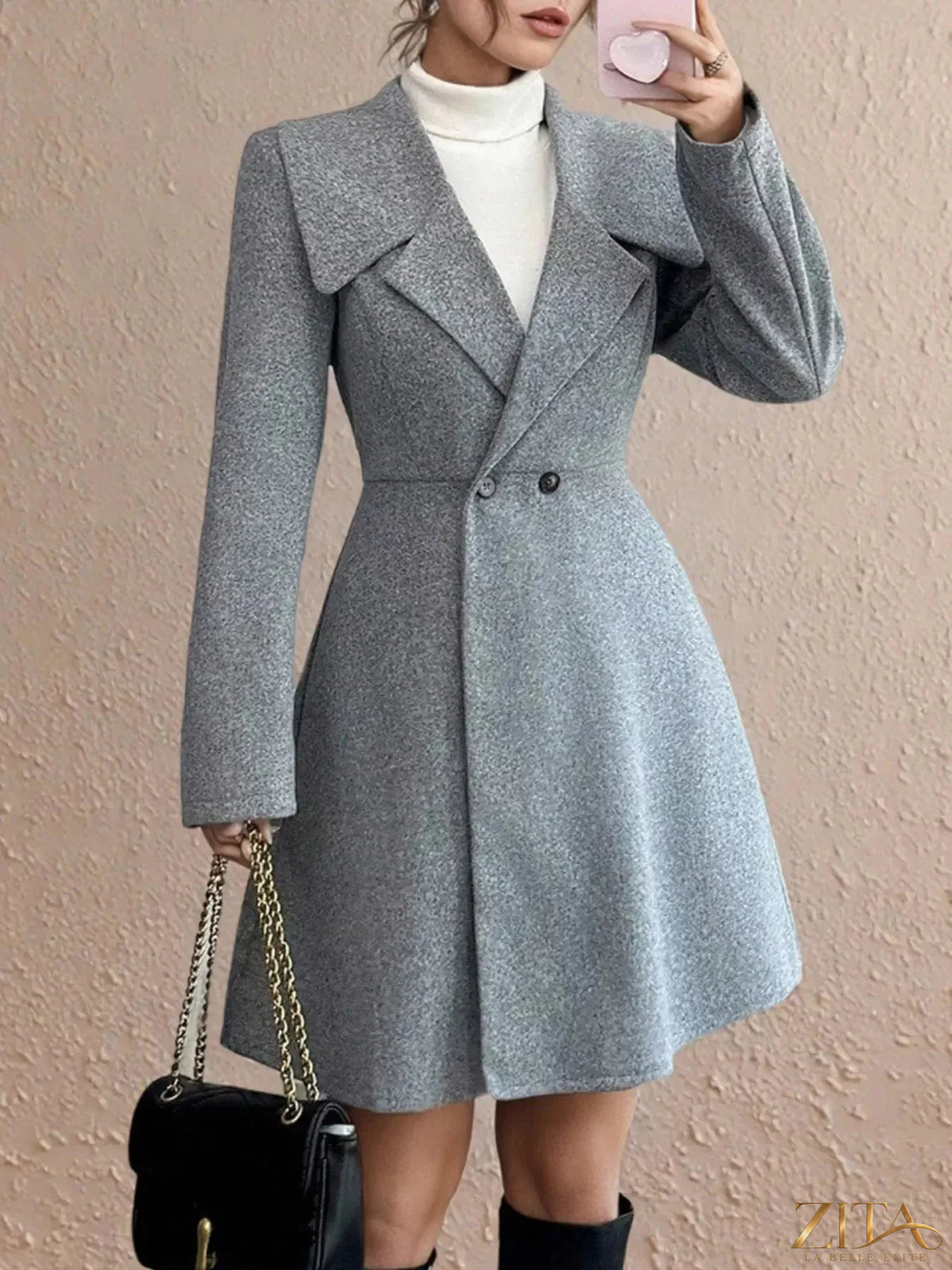 Zita La Belle Elite double-breasted wool blend coat hanging on a wooden hanger, showcasing its tailored design and classic style.