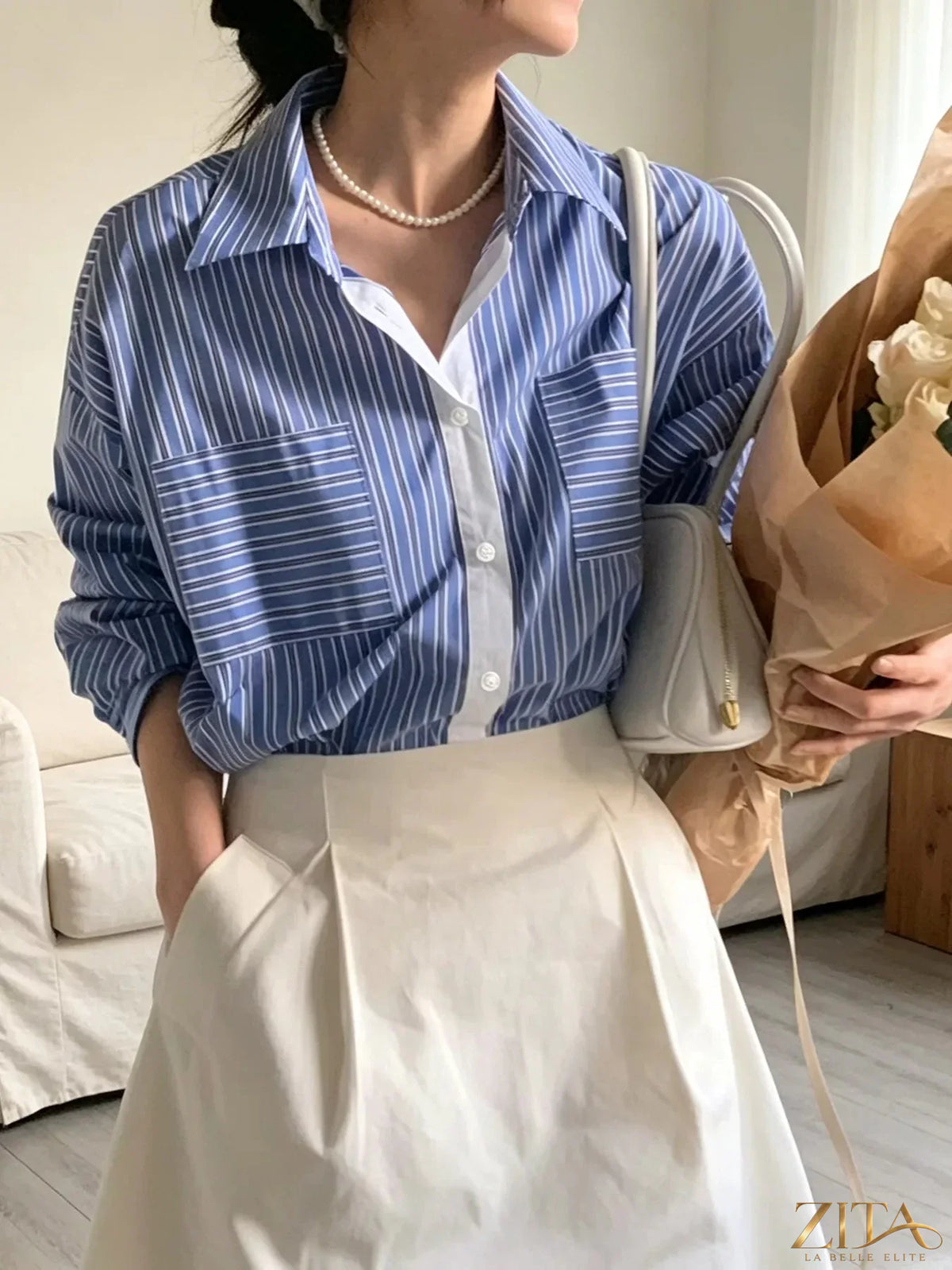 Zita La Belle Elite striped button-down shirt with blue and white vertical stripes, featuring a classic collar and front buttons.