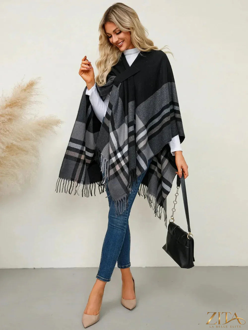Trendsi fringe contrast plaid poncho featuring a stylish plaid pattern with fringed edges and a cozy, oversized fit.