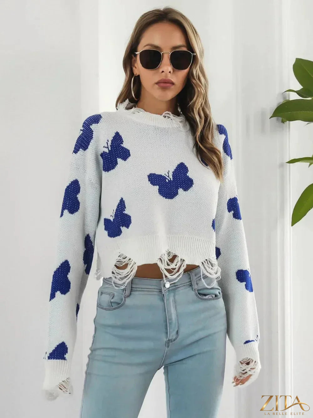 Zita La Belle Elite distressed butterfly cropped sweater showing a faded butterfly design and a relaxed, cropped fit.