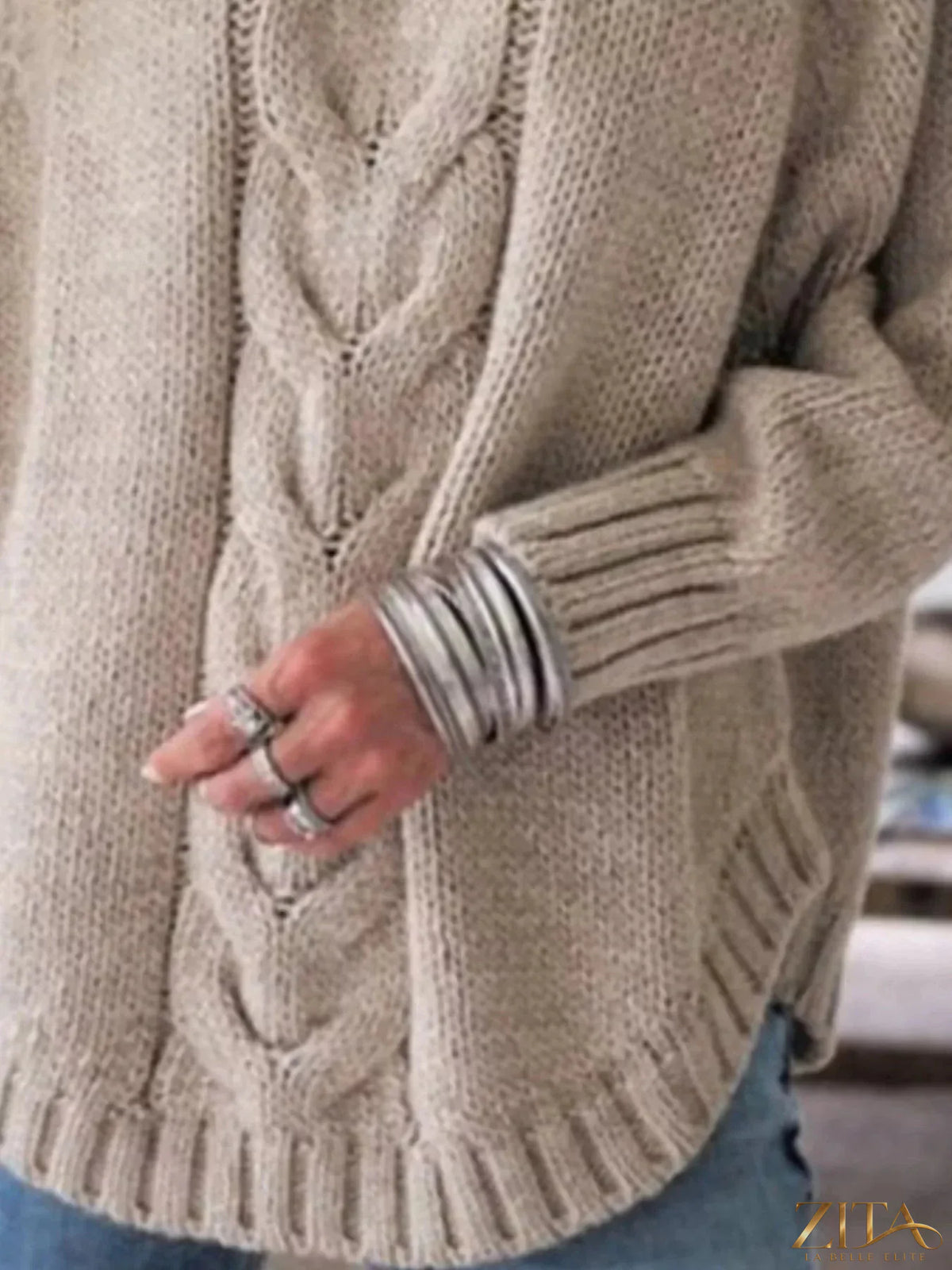 Zita La Belle Elite cable-knit long sleeve sweater in neutral color, featuring a textured knit pattern and crew neckline.